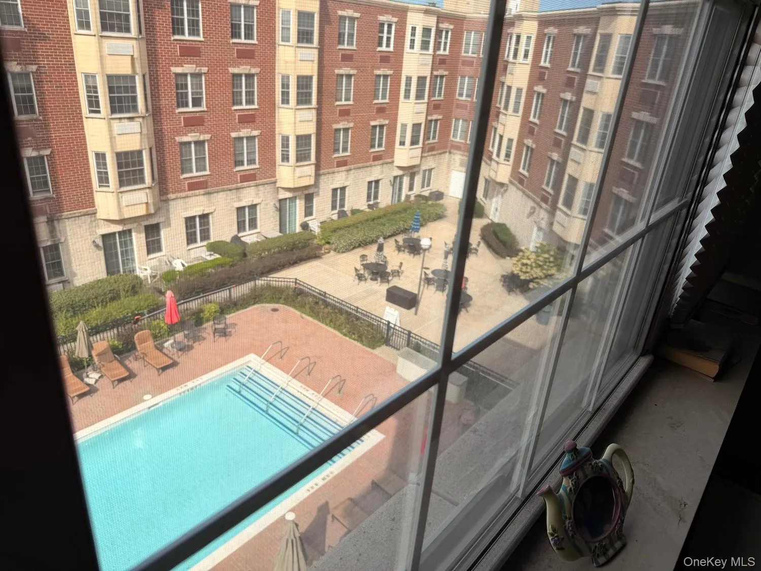 View of courtyard and heated pool from the living room. View of courtyard and heated pool from the living room.