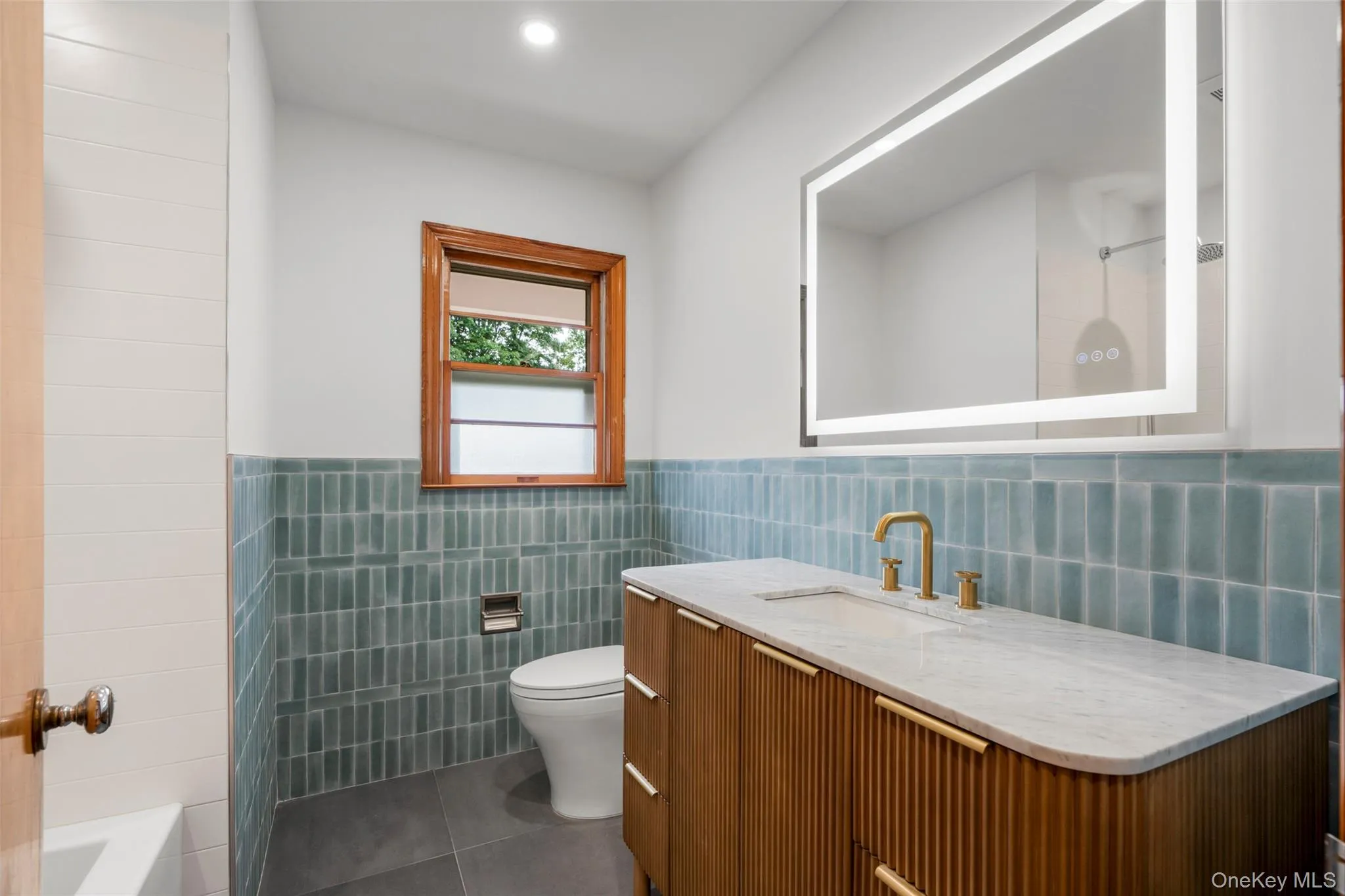 Full bath with tub, glazed tile and fogless mirror Full bath with tub, glazed tile and fogless mirror