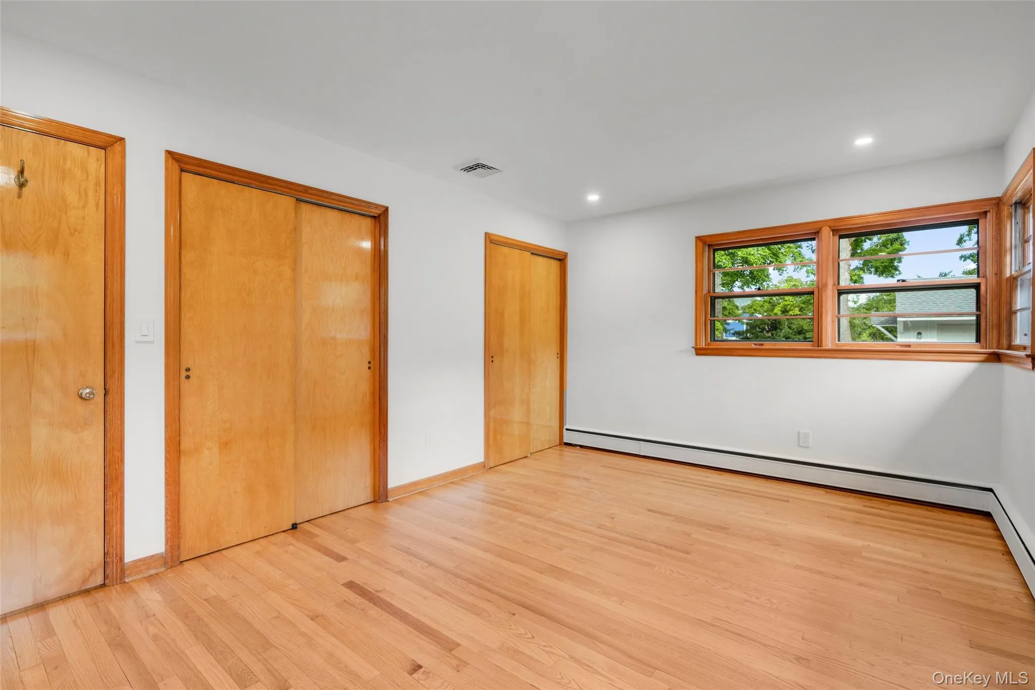Primary bedroom with two large closets and mid-century window detail Primary bedroom with two large closets and mid-century window detail