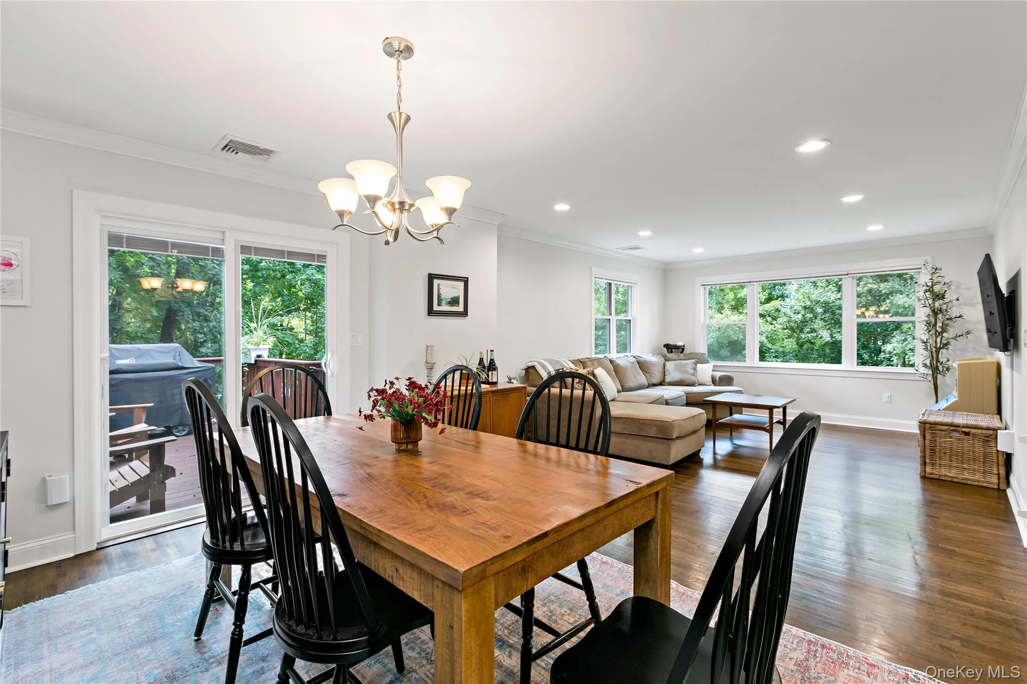Dining Room with open layout to living room and sliding glass door to deck Dining Room with open layout to living room and sliding glass door to deck