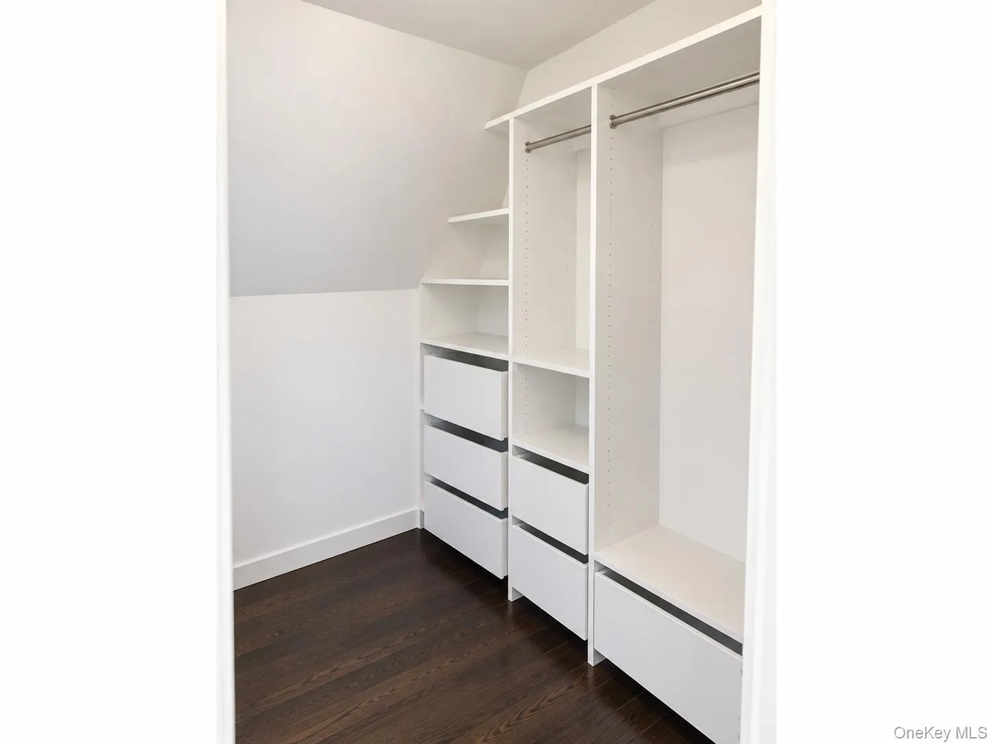 Upstairs bedroom suite features a walk-in closet with a full shelving system and built-in drawers. Upstairs bedroom suite features a walk-in closet with a full shelving system and built-in drawers.