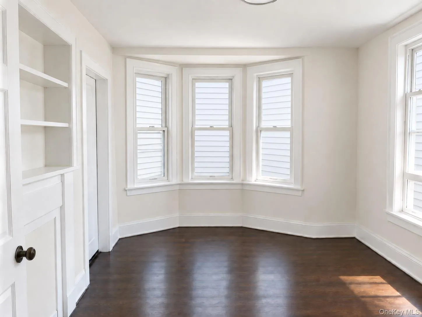 Sunny, comfortable living room with decorative fireplace and window facing Beekman Avenue. Sunny, comfortable living room with decorative fireplace and window facing Beekman Avenue.