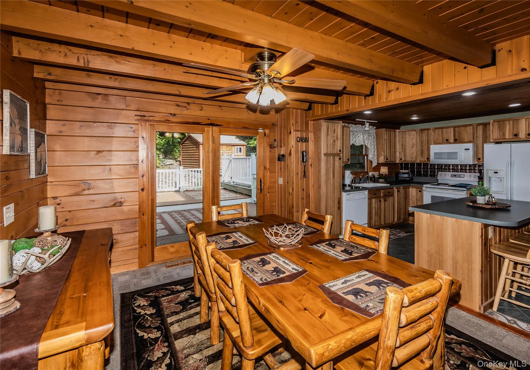 Wood-paneled interior featuring exposed ceiling beams and recessed lighting Wood-paneled interior featuring exposed ceiling beams and recessed lighting