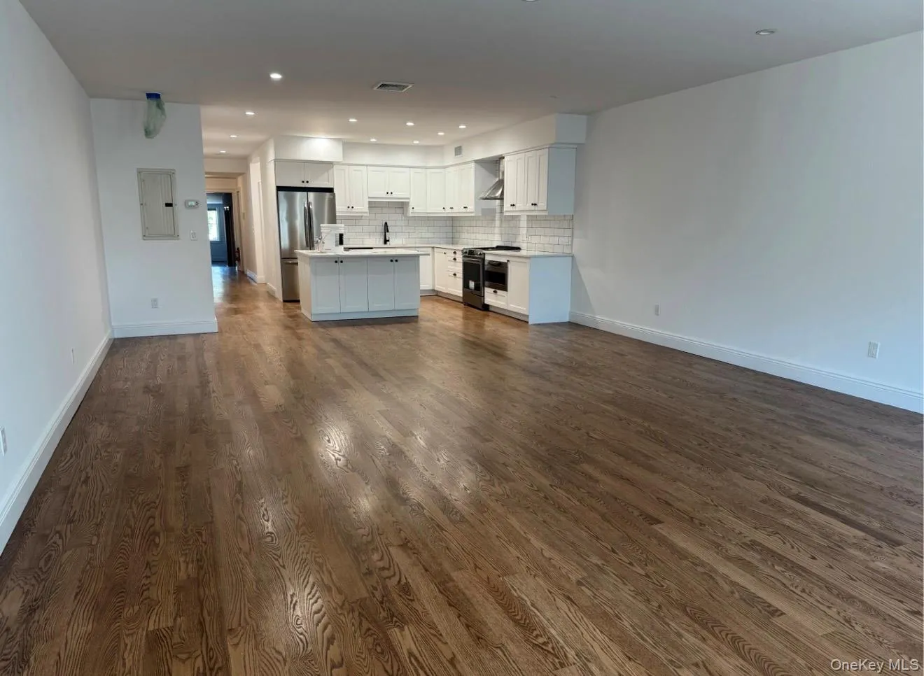 Unstated great room from front windows towards kitchen Unstated great room from front windows towards kitchen