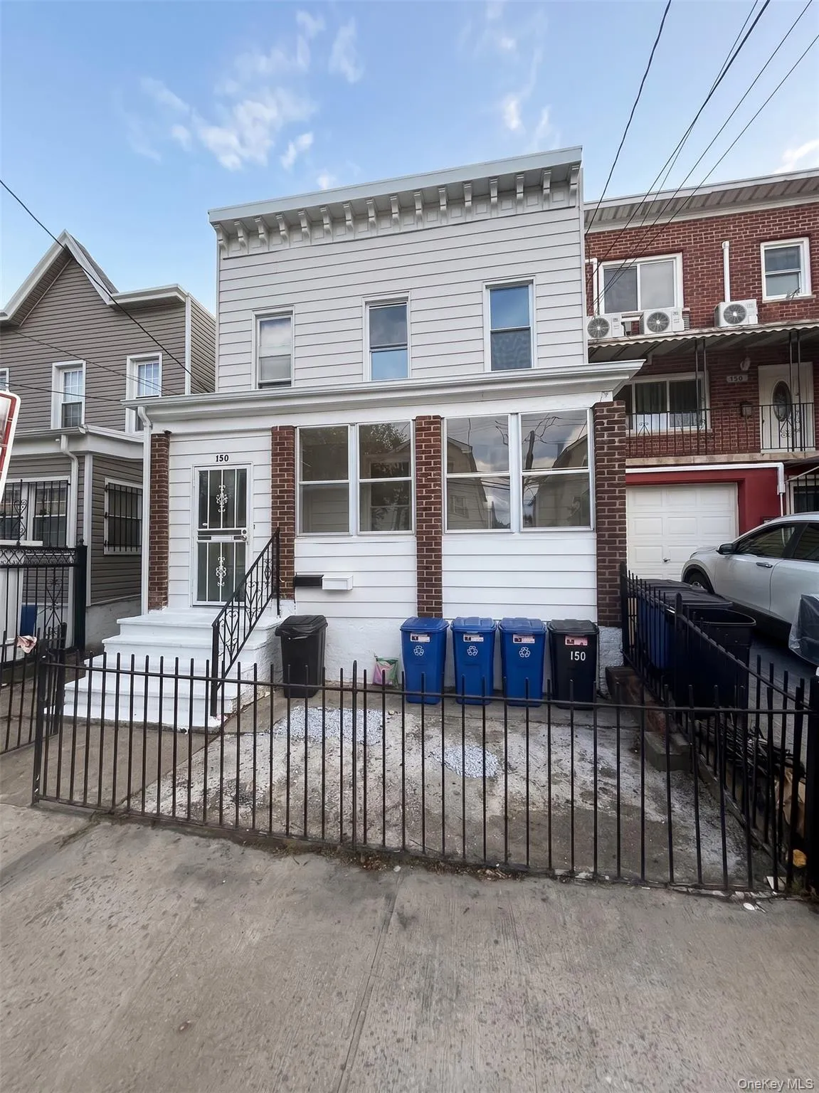 Two-story residential facade featuring horizontal siding and decorative cornice Two-story residential facade featuring horizontal siding and decorative cornice