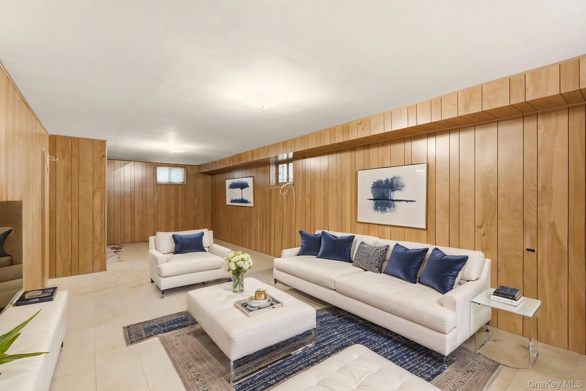 Wood-paneled walls with integrated door, recessed ceiling lighting, and light-toned flooring Wood-paneled walls with integrated door, recessed ceiling lighting, and light-toned flooring
