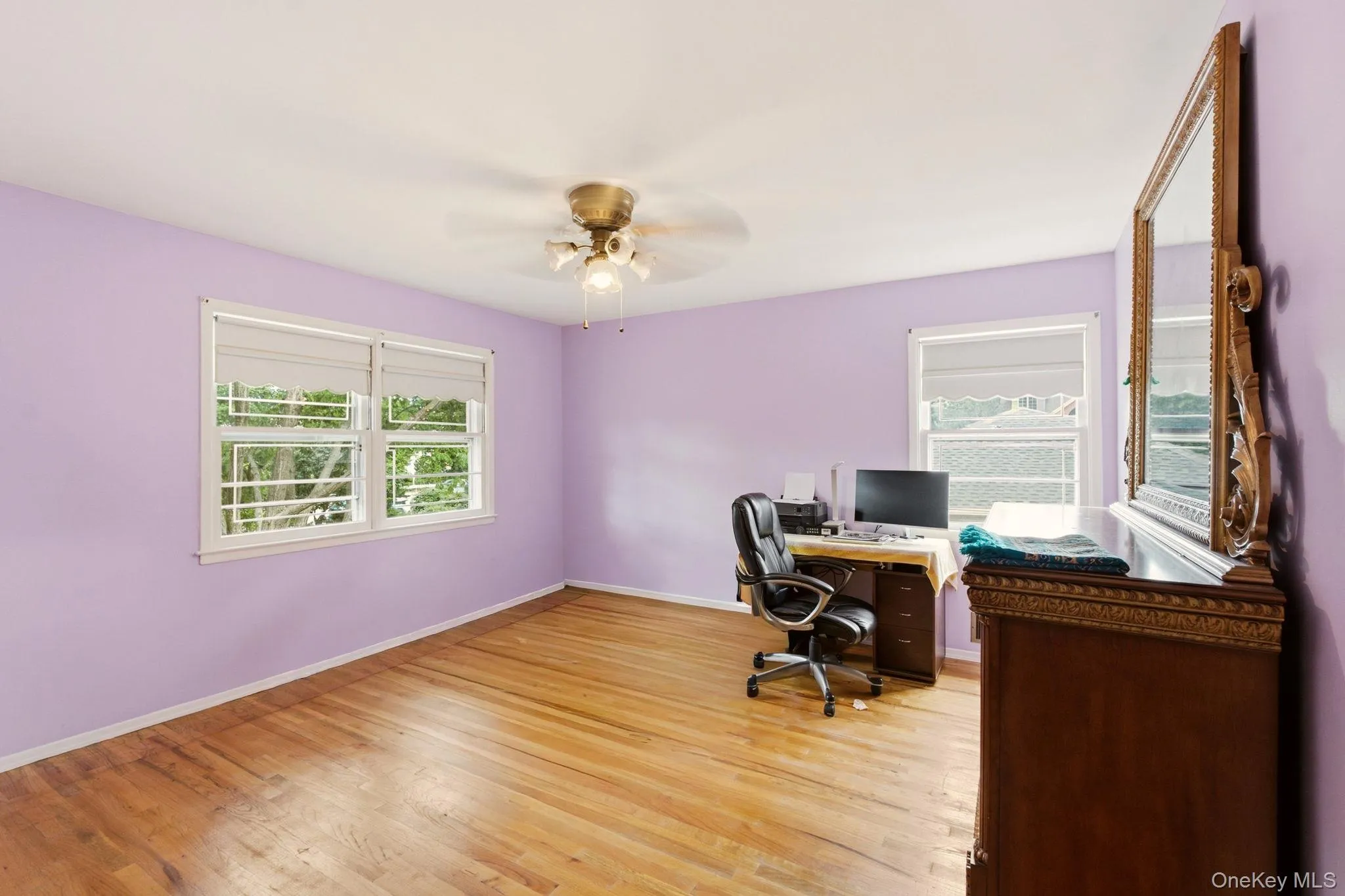 Hardwood flooring, multiple windows, ceiling fan, and ample wall space Hardwood flooring, multiple windows, ceiling fan, and ample wall space