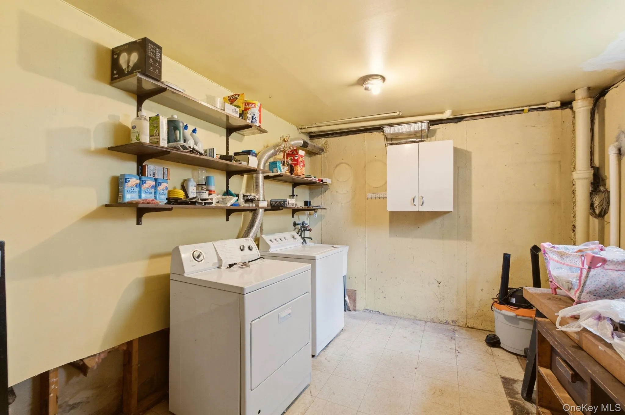 Wall-mounted shelving, built-in wall cabinet, and overhead lighting Wall-mounted shelving, built-in wall cabinet, and overhead lighting
