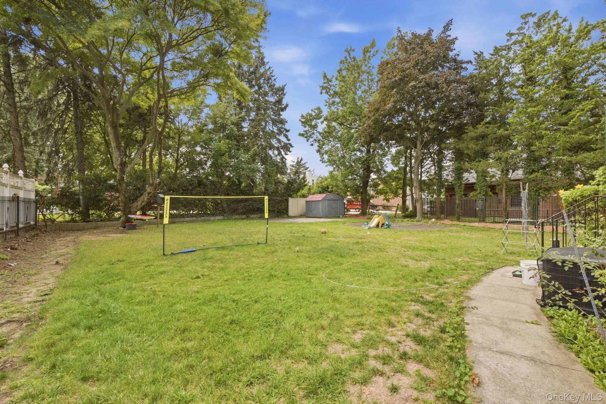 Expansive grassy yard with mature trees Expansive grassy yard with mature trees