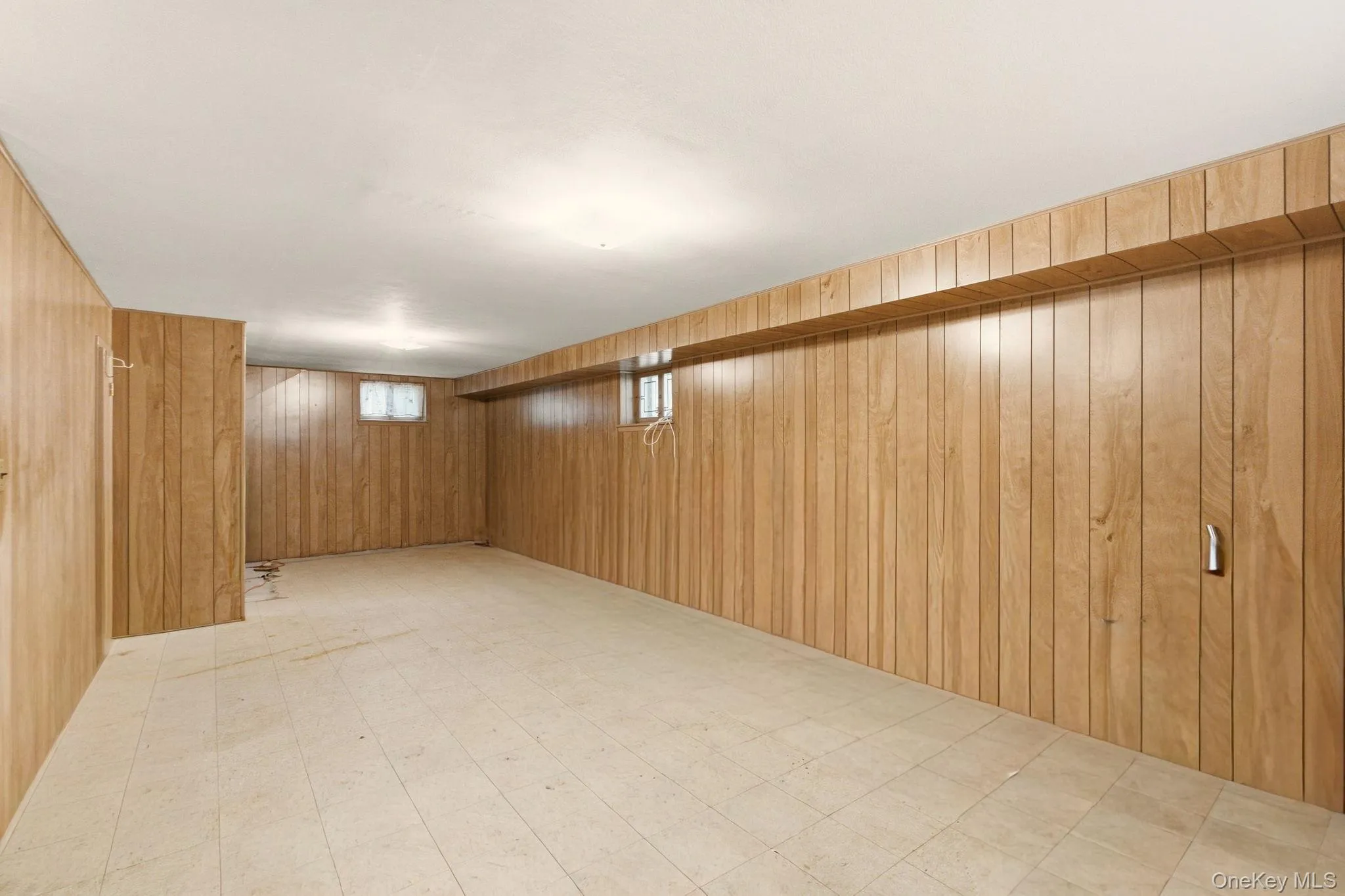Wood paneling throughout, multiple windows for natural light, and tile flooring Wood paneling throughout, multiple windows for natural light, and tile flooring