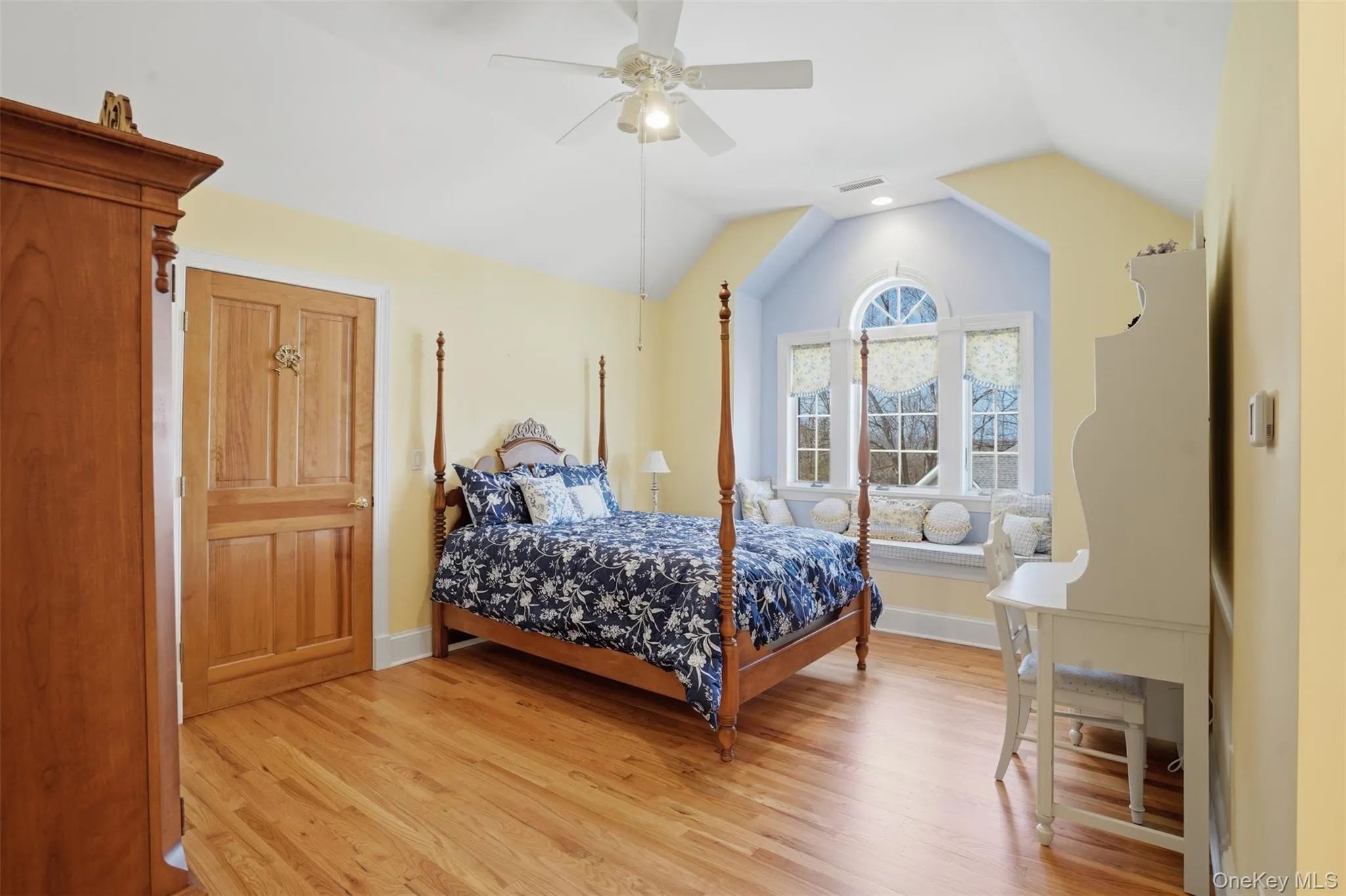 This room features light hardwood flooring, a window seat with a view, and a ceiling fan This room features light hardwood flooring, a window seat with a view, and a ceiling fan