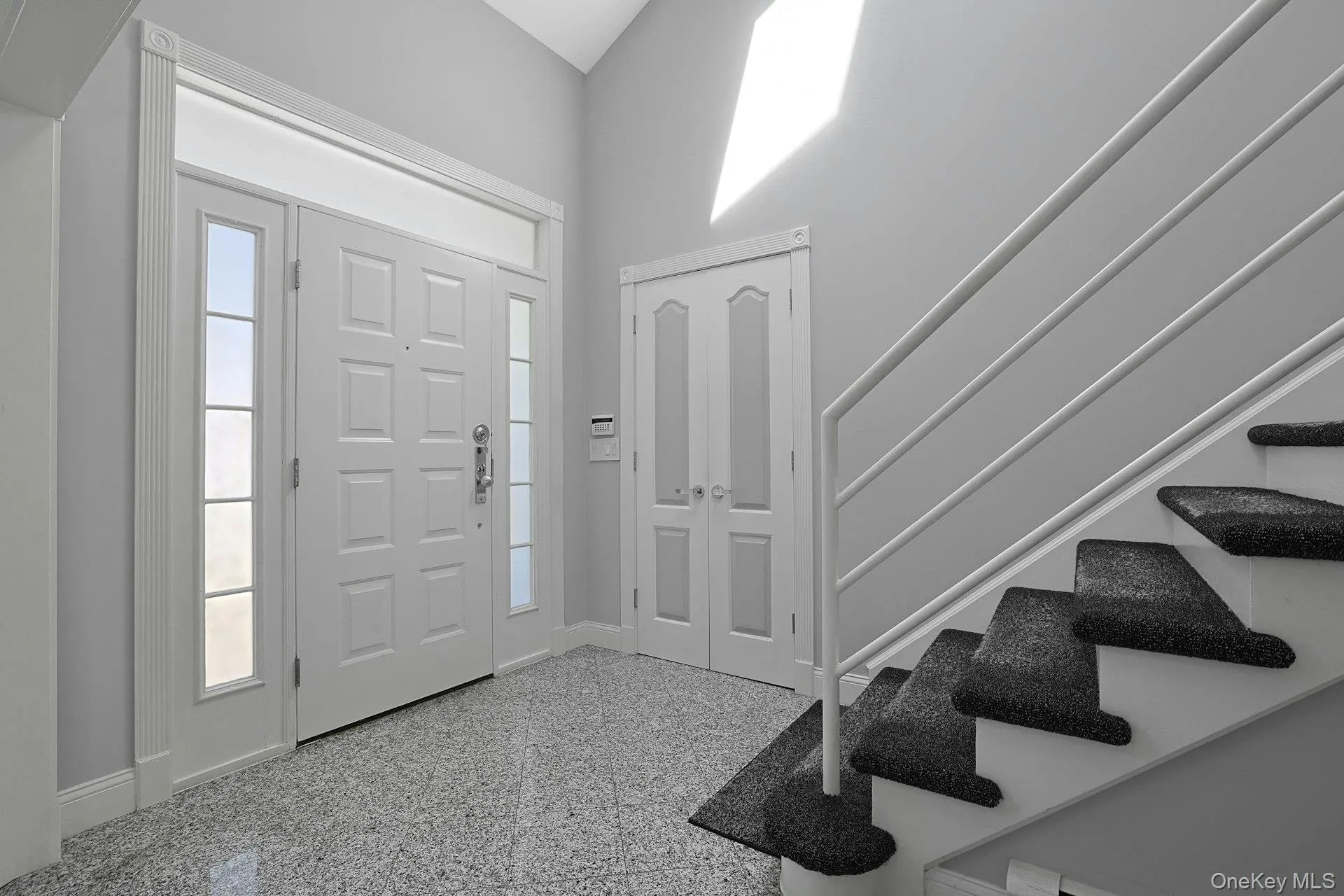 Sun-filled gracious double-height entry Sun-filled gracious double-height entry