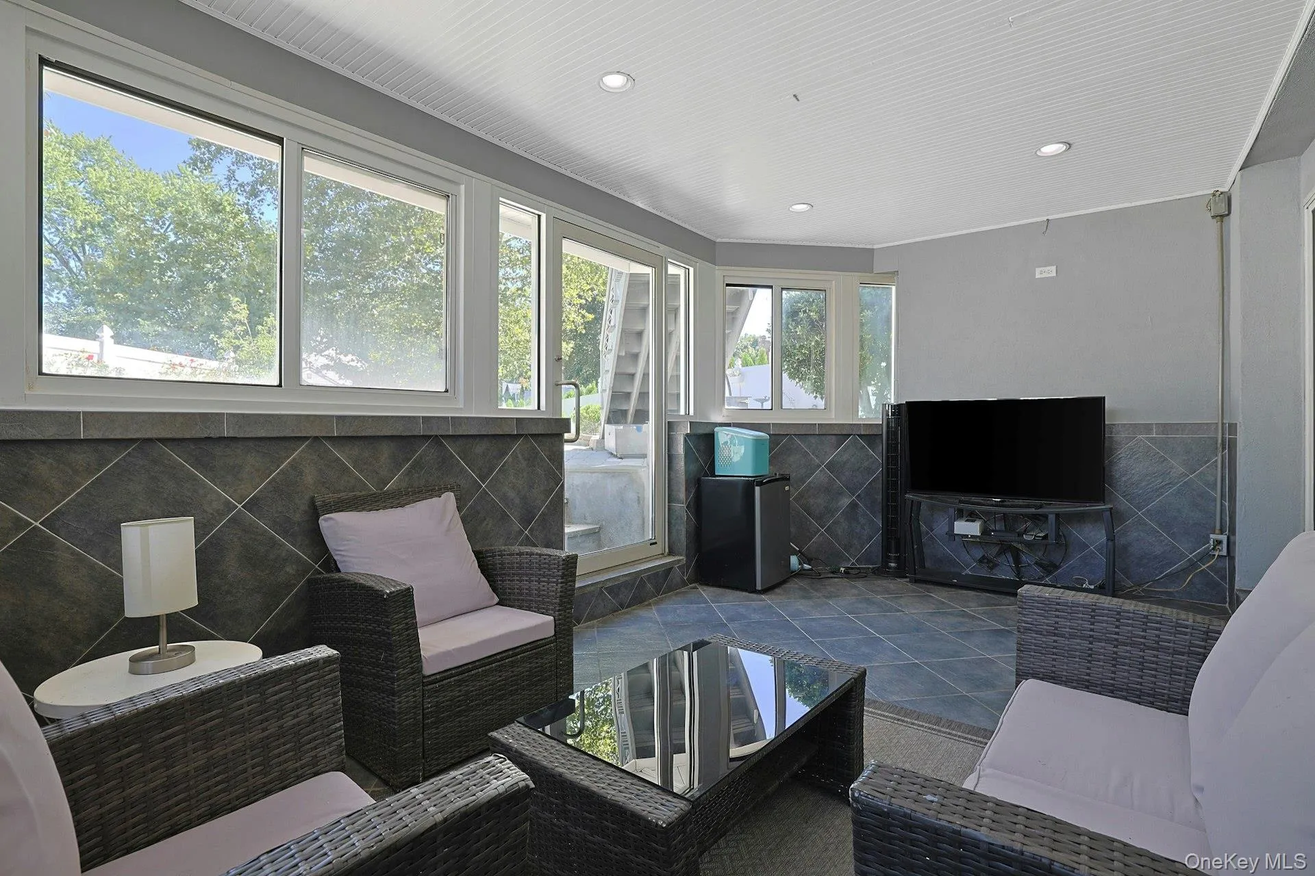 sun room with door to back property sun room with door to back property