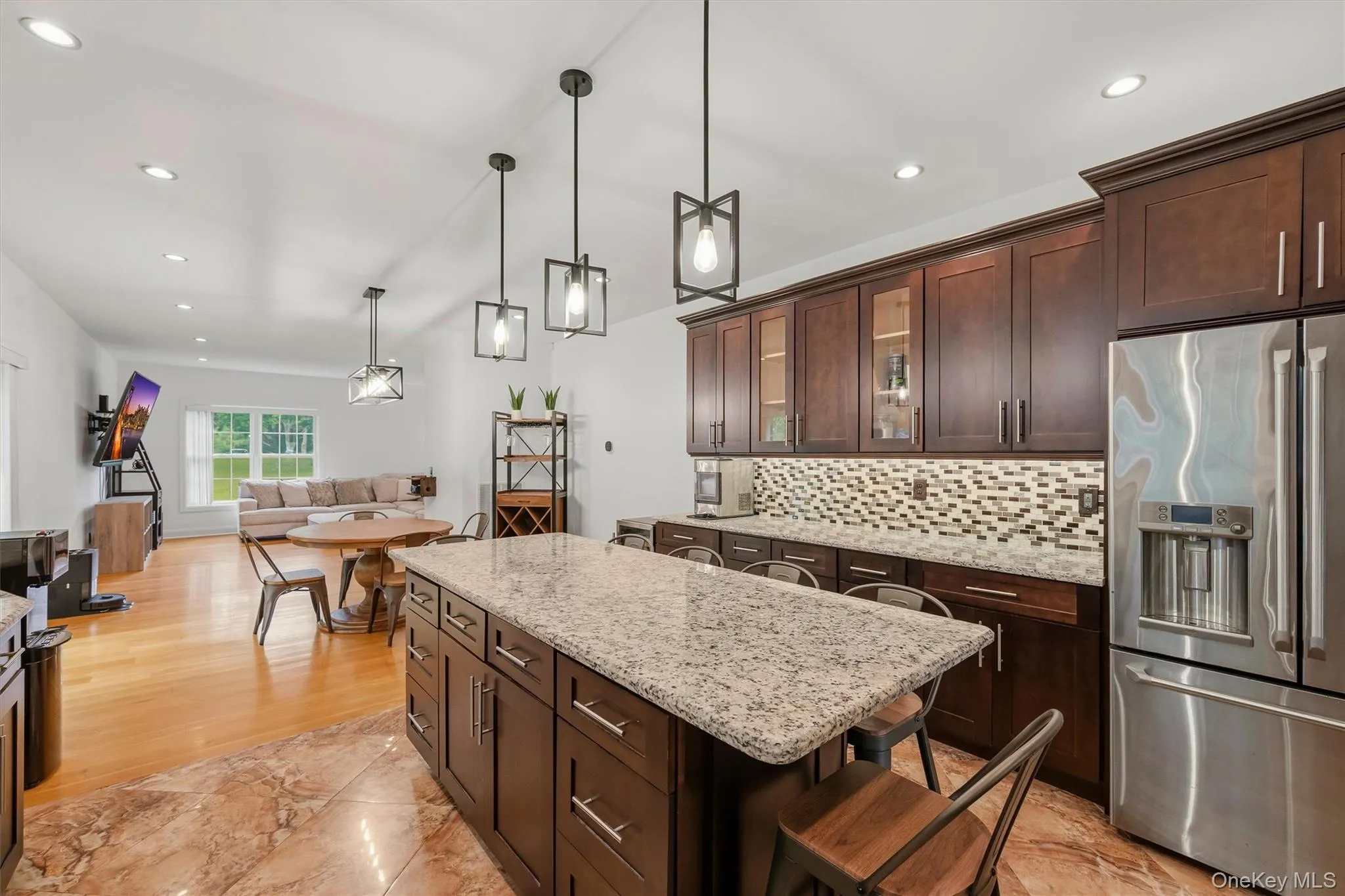 Kitchen with 7 foot 7 inch center island that seats 6, Cafe appliances, granite countertops, tile backsplash, uplighting, Recessed lighting, marble tile floors and 9 foot ceilings. Kitchen with 7 foot 7 inch center island that seats 6, Cafe appliances, granite countertops, tile backsplash, uplighting, Recessed lighting, marble tile floors and 9 foot ceilings.