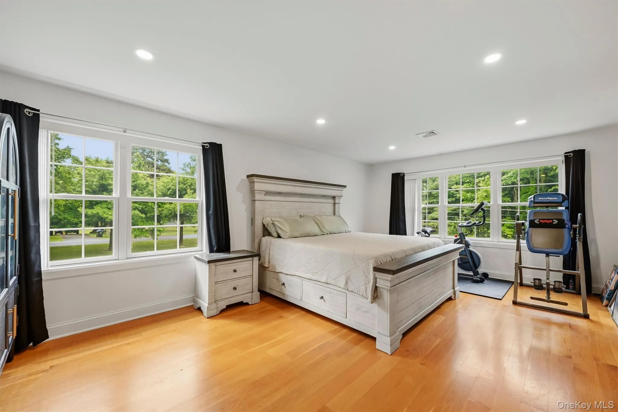 15x19 Primary Bedroom with recessed lighting, wide oak flooring and balcony access. 15x19 Primary Bedroom with recessed lighting, wide oak flooring and balcony access.