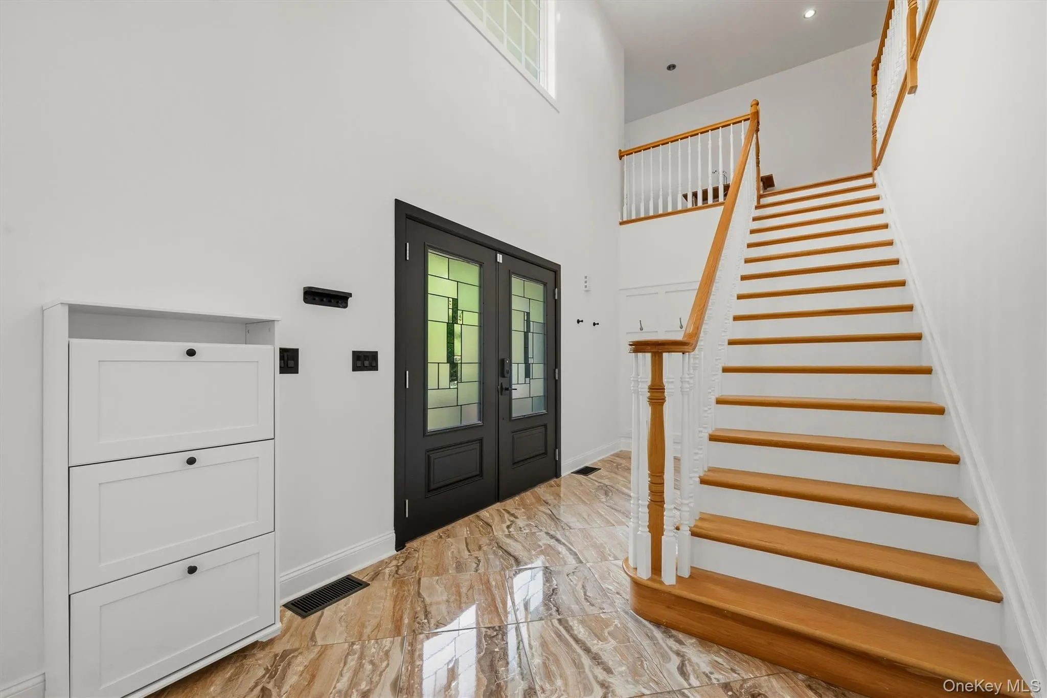 Grand two story foyer with marble tile. Grand two story foyer with marble tile.