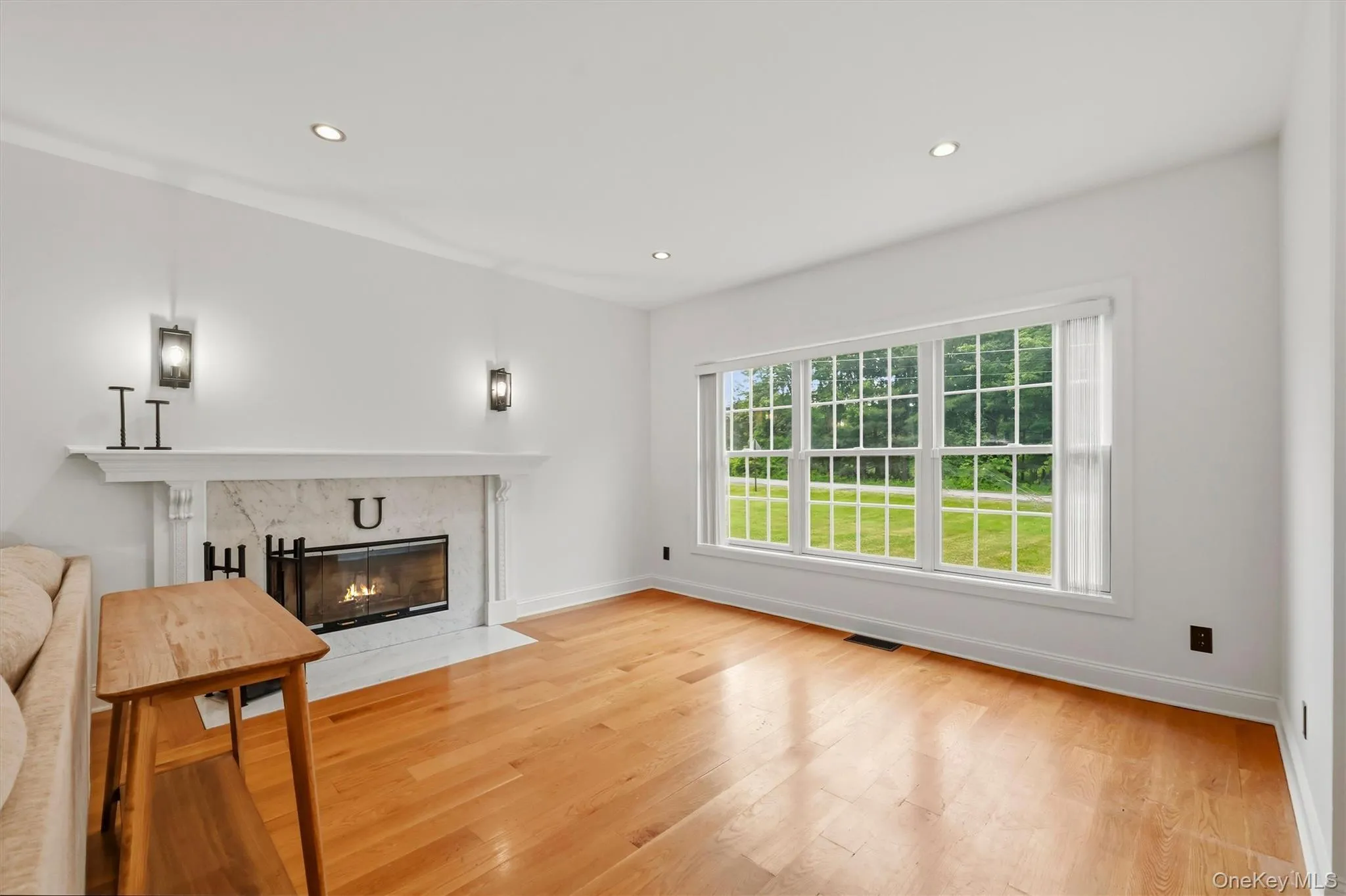 Carrera marble tiled wood-burning fireplace, Anderson windows and 9 foot ceilings. Carrera marble tiled wood-burning fireplace, Anderson windows and 9 foot ceilings.