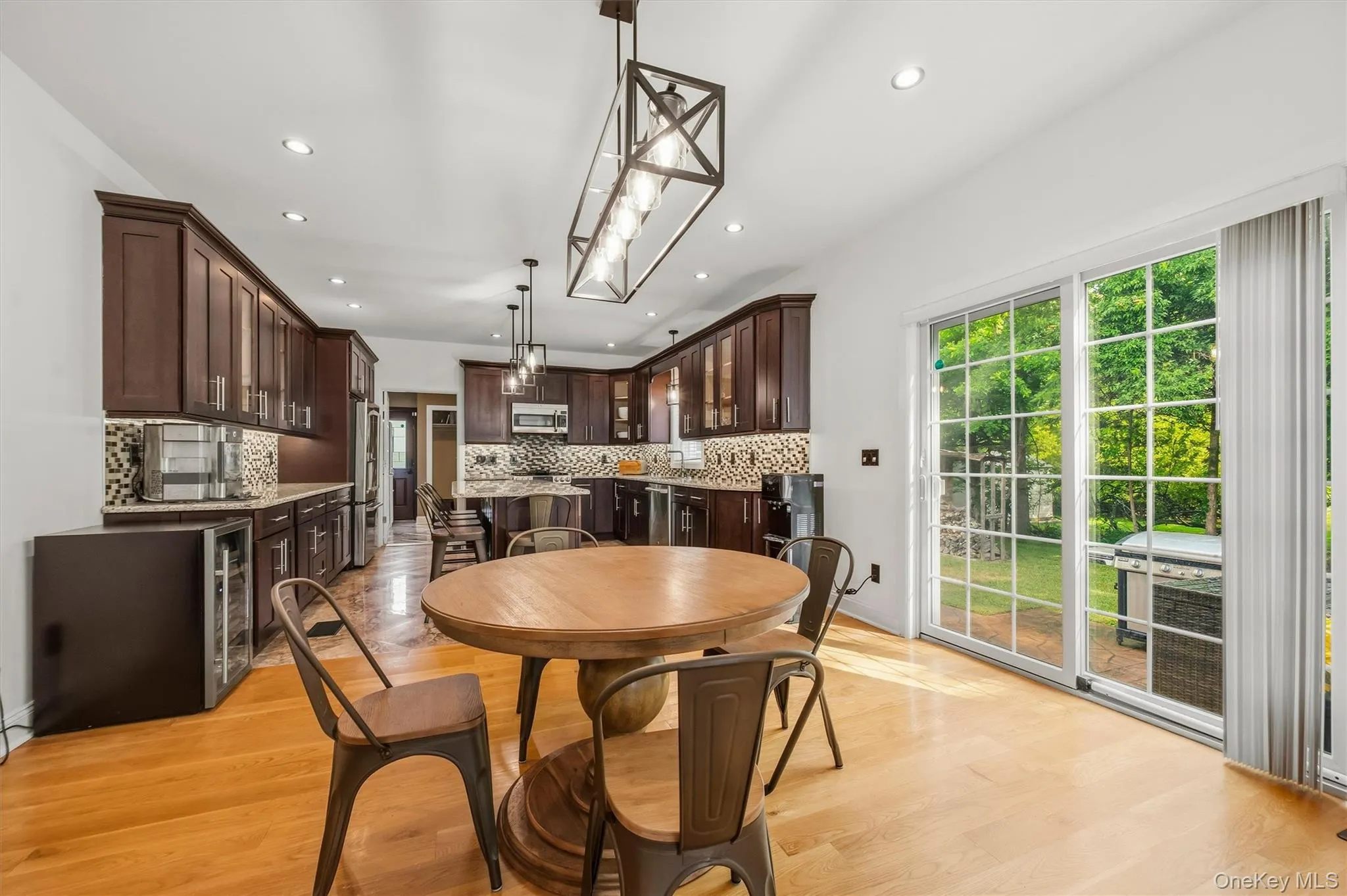 Dining room, with Anderson slider, that leads to a stamped concrete patio. Open to kitchen. Recessed lighting, wide plank white oak flooring and 9 foot ceilings. Dining room, with Anderson slider, that leads to a stamped concrete patio. Open to kitchen. Recessed lighting, wide plank white oak flooring and 9 foot ceilings.