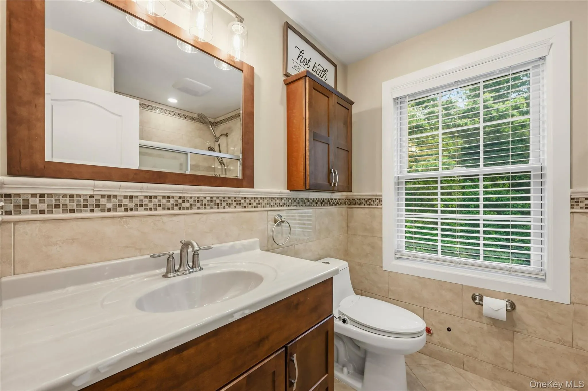 Hallway bathroom, marble tile, Anderson window, recessed lighting. Hallway bathroom, marble tile, Anderson window, recessed lighting.