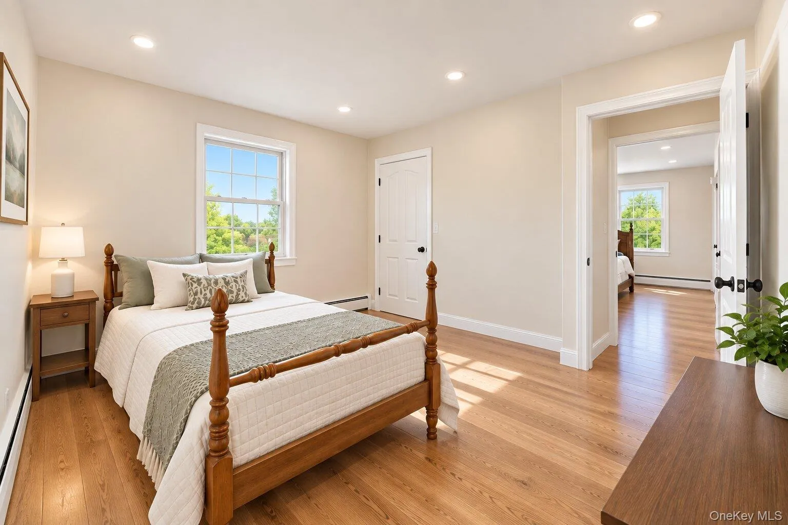 Recessed lighting, wood-finish flooring, white trim, single window, and solid core doors Recessed lighting, wood-finish flooring, white trim, single window, and solid core doors