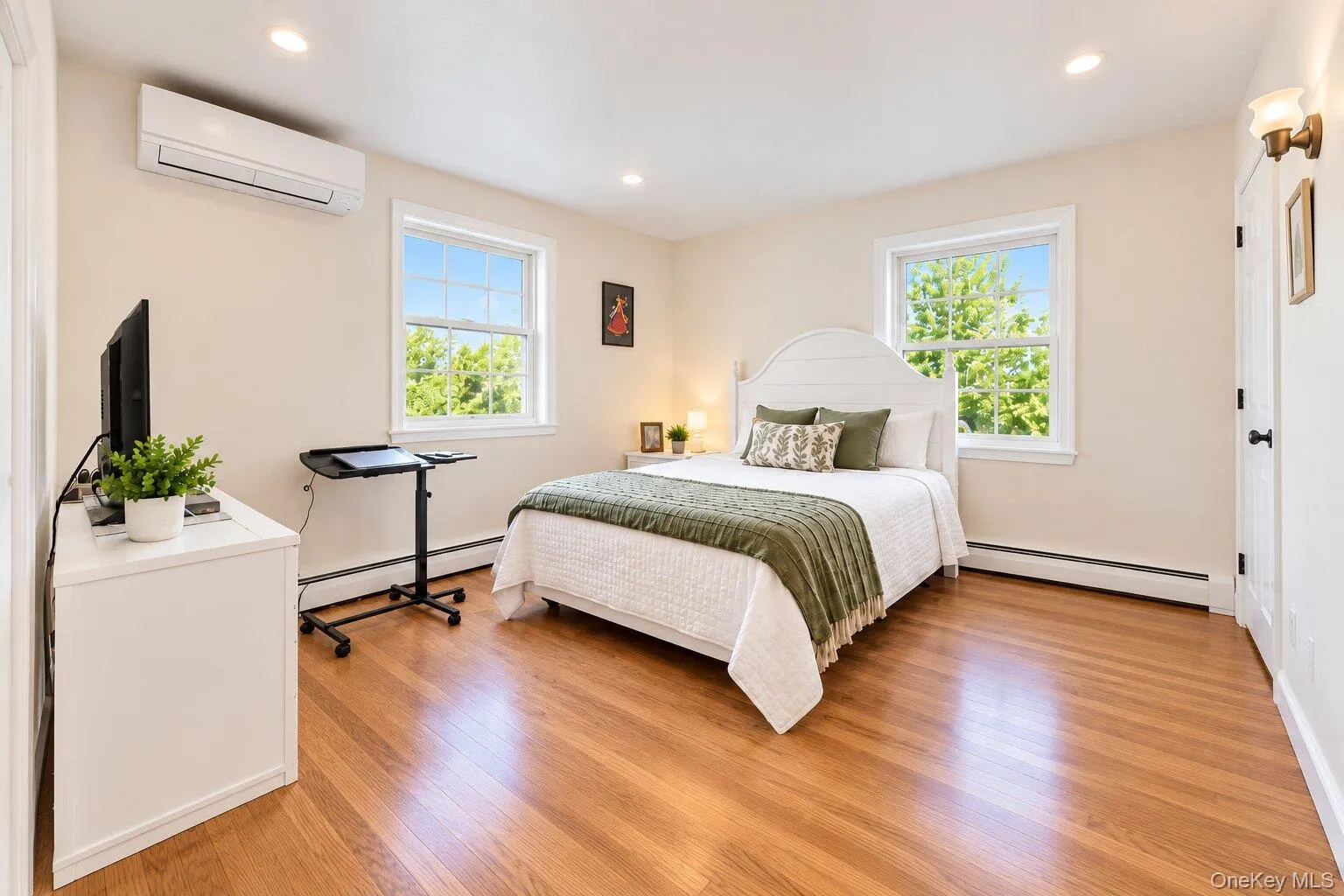 Hardwood flooring, recessed lighting, wall-mounted light fixture, and an integrated wall unit Hardwood flooring, recessed lighting, wall-mounted light fixture, and an integrated wall unit