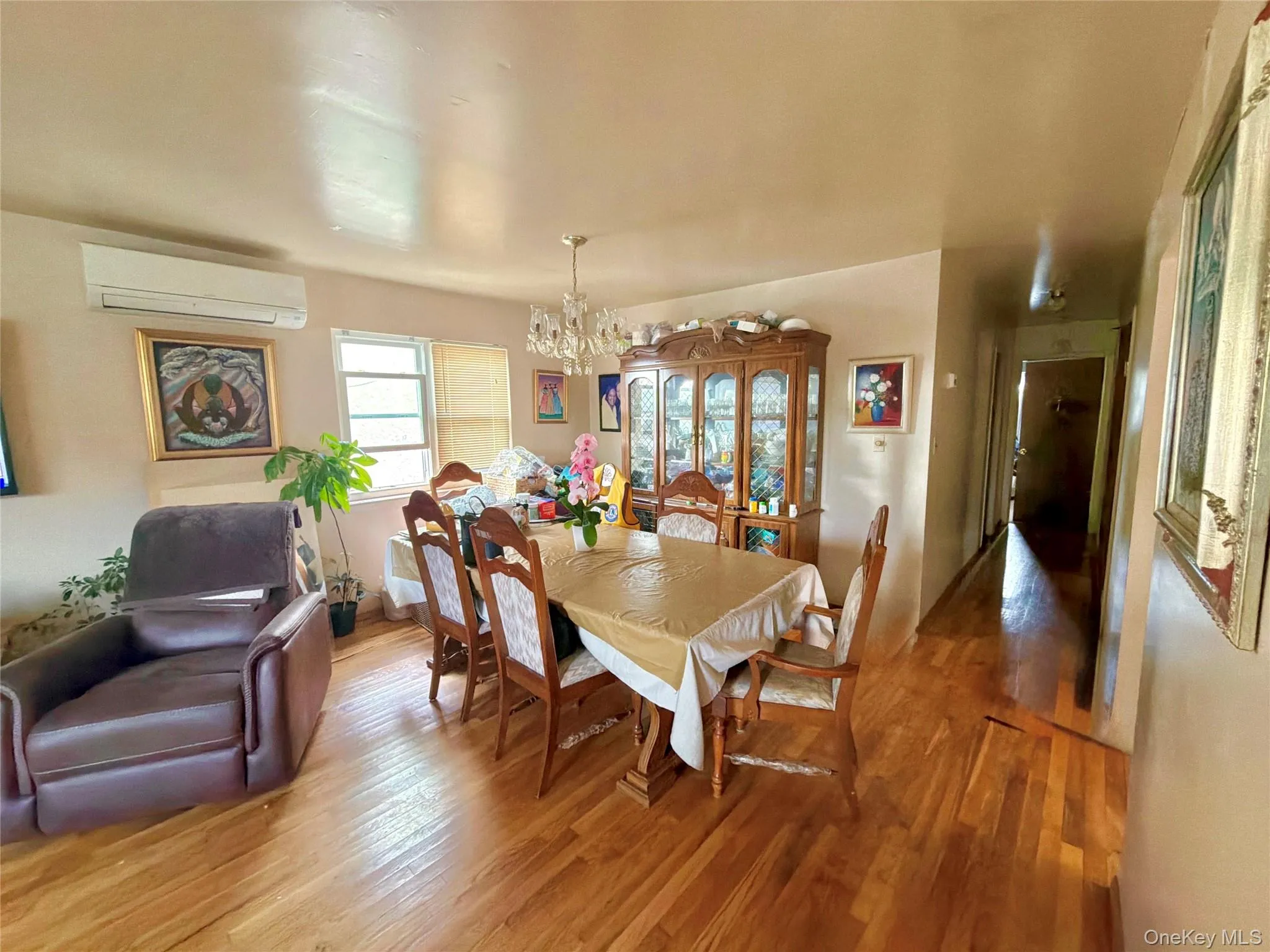 Hardwood flooring throughout, with a crystal chandelier and prominent window Hardwood flooring throughout, with a crystal chandelier and prominent window