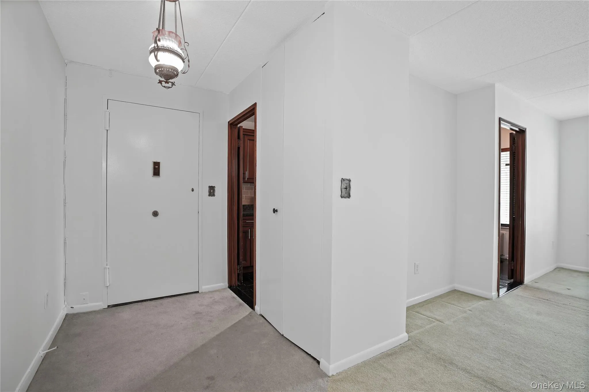 Entrance to the kitchen, and a large coat closet Entrance to the kitchen, and a large coat closet