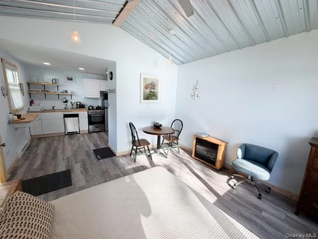Vaulted corrugated metal ceiling complemented by wood-finish flooring Vaulted corrugated metal ceiling complemented by wood-finish flooring