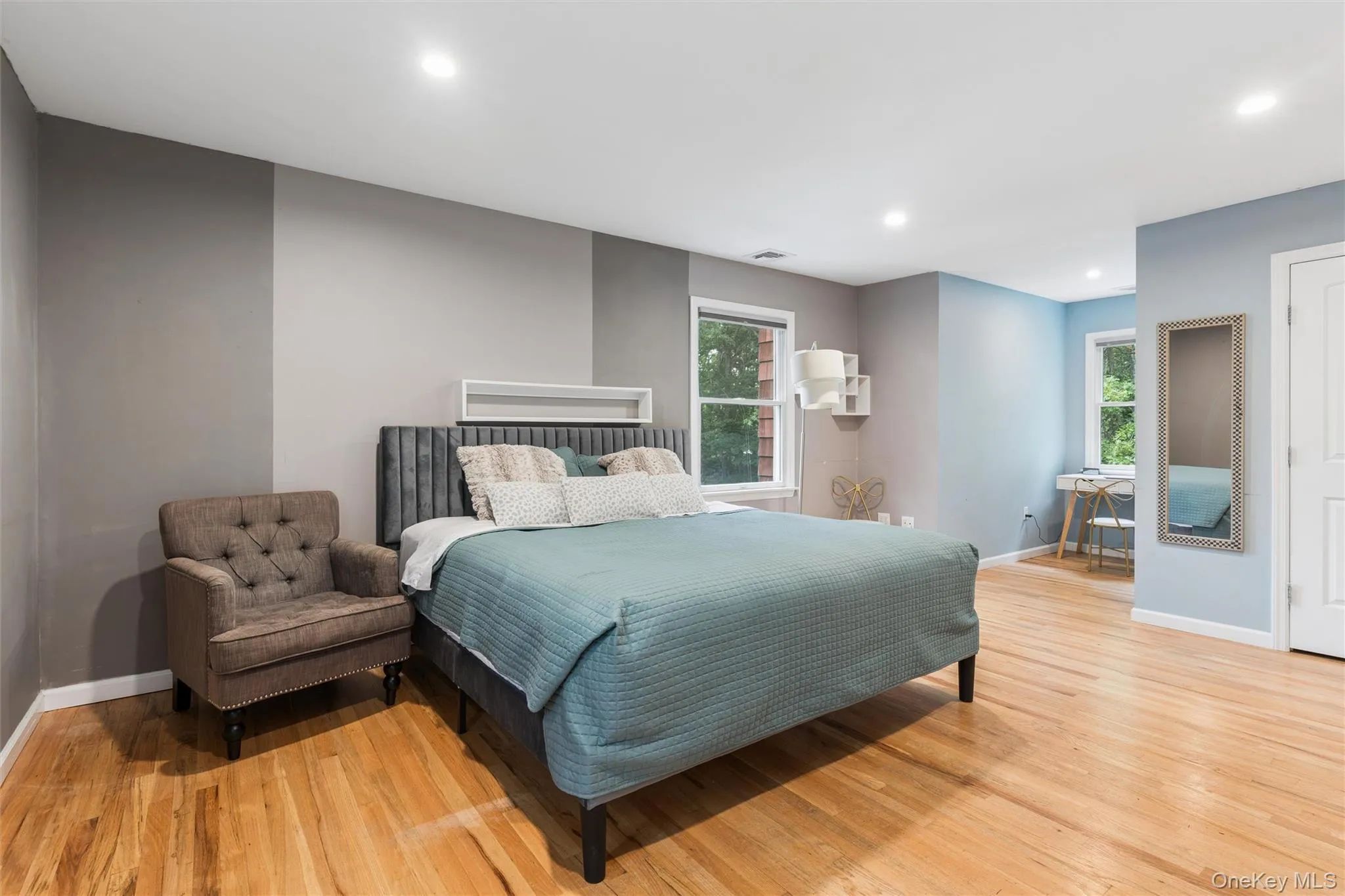 Wood-finish flooring, recessed lighting, and multiple windows Wood-finish flooring, recessed lighting, and multiple windows