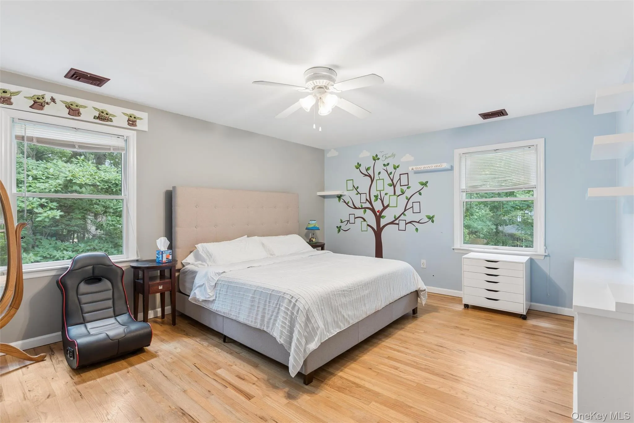 Hardwood flooring, two windows with natural light, ceiling fan with light fixture, and painted walls Hardwood flooring, two windows with natural light, ceiling fan with light fixture, and painted walls