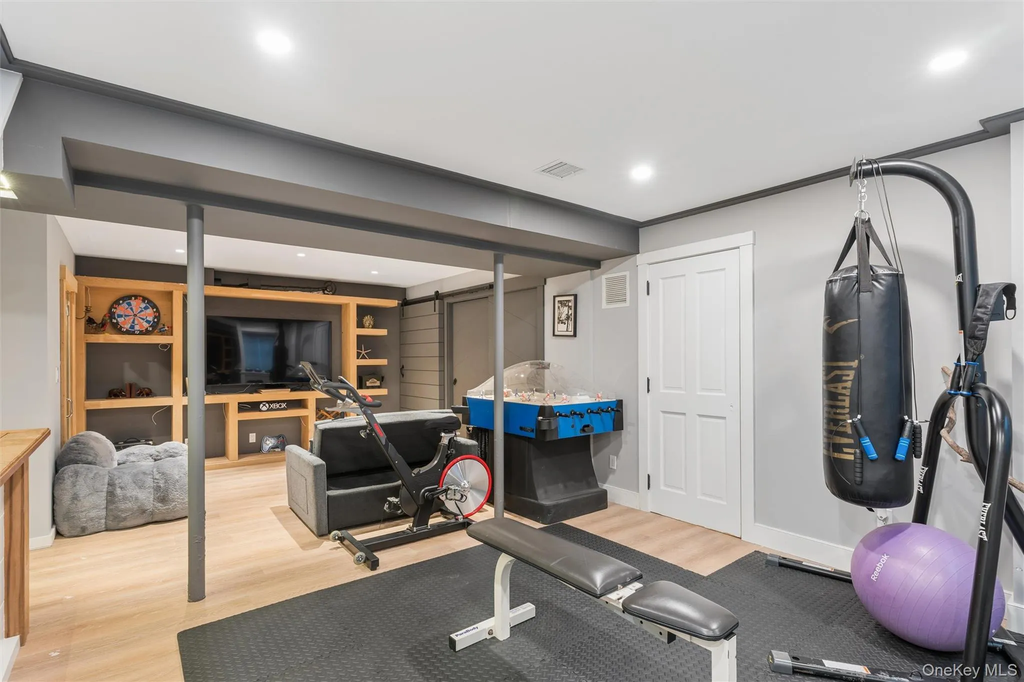 Recessed lighting illuminates the open-concept space with wood-finish flooring Recessed lighting illuminates the open-concept space with wood-finish flooring