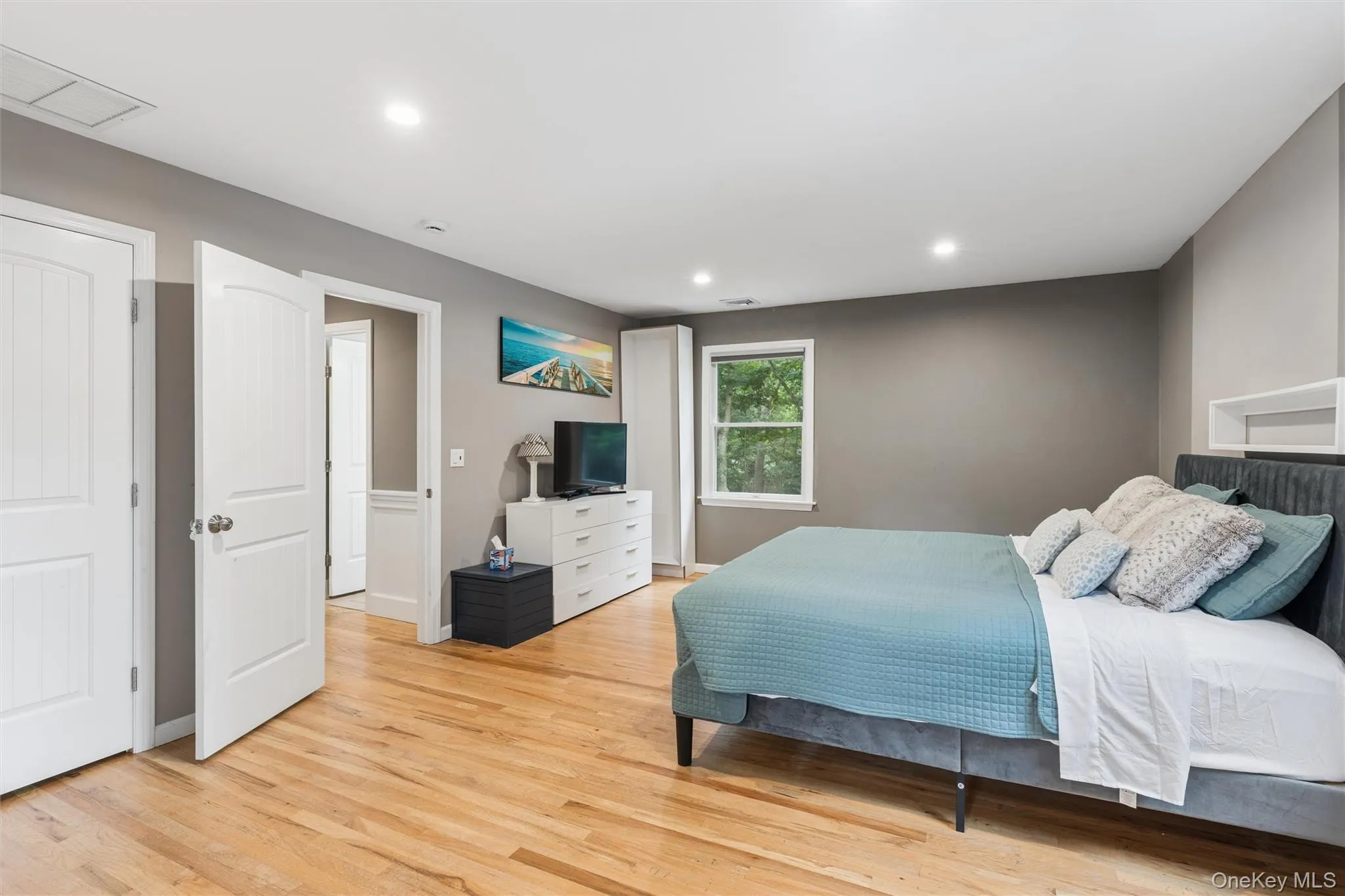 Hardwood flooring, recessed lighting, white interior doors, and a window with natural light Hardwood flooring, recessed lighting, white interior doors, and a window with natural light