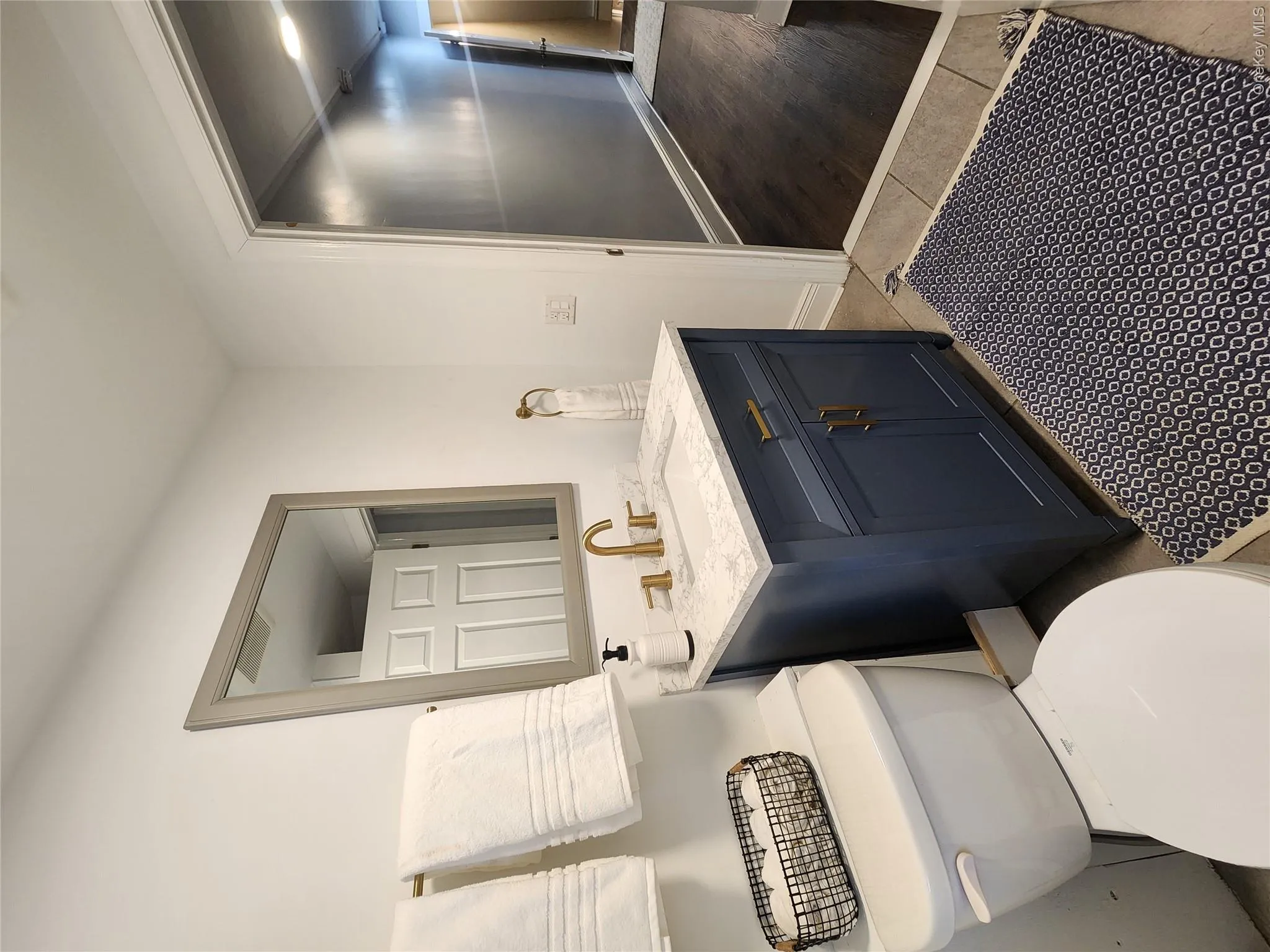 Half bathroom with vanity and wood finished floors Half bathroom with vanity and wood finished floors