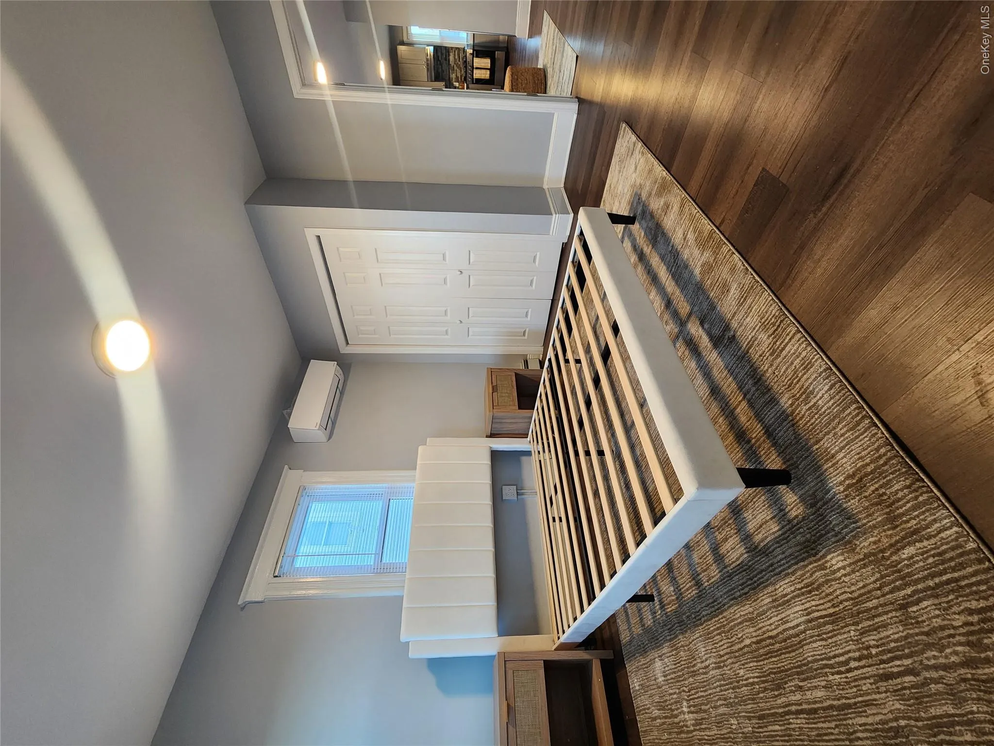 Bedroom with wood finished floors and a closet Bedroom with wood finished floors and a closet