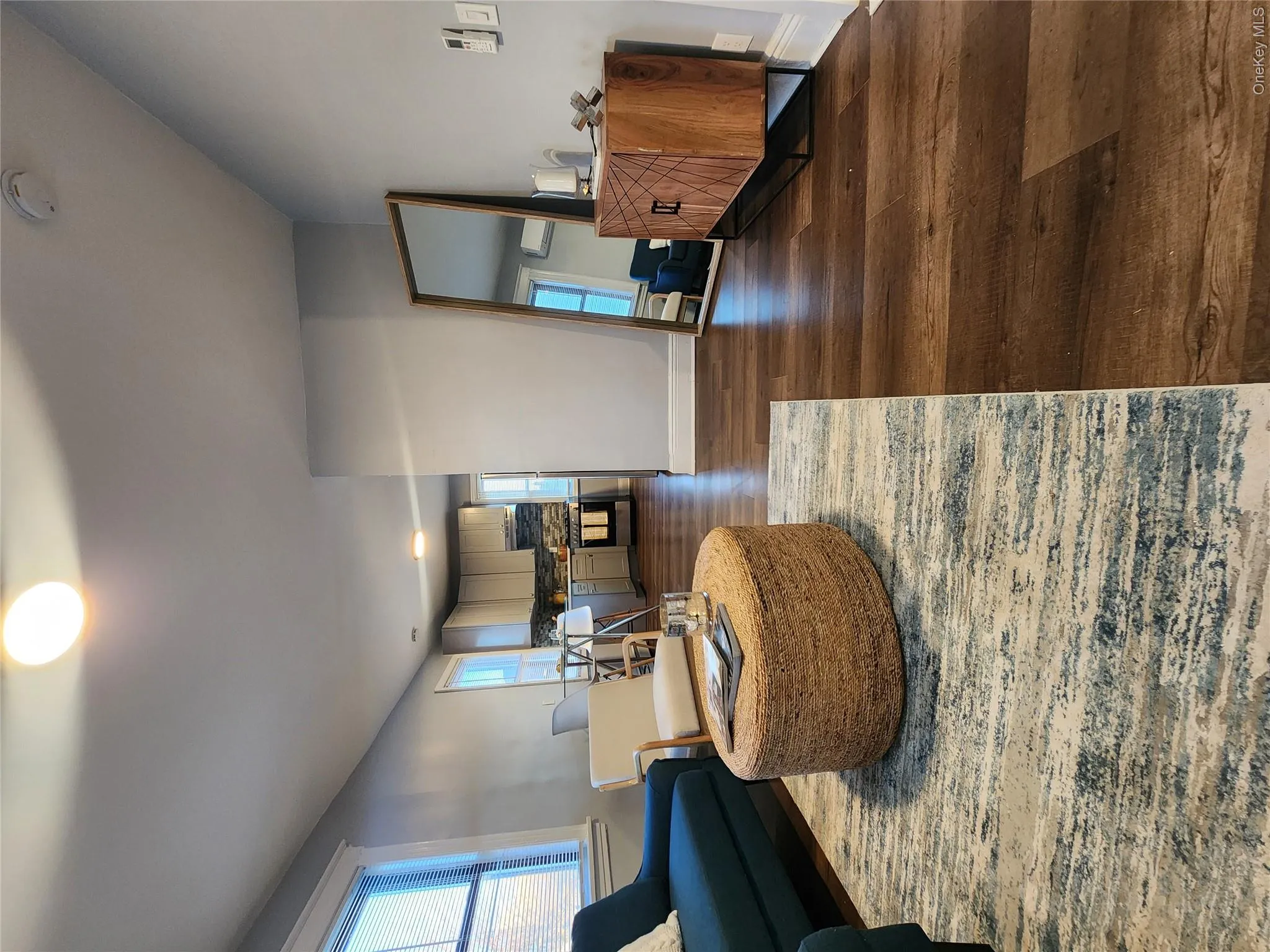 Living room featuring dark wood-style floors and plenty of natural light Living room featuring dark wood-style floors and plenty of natural light
