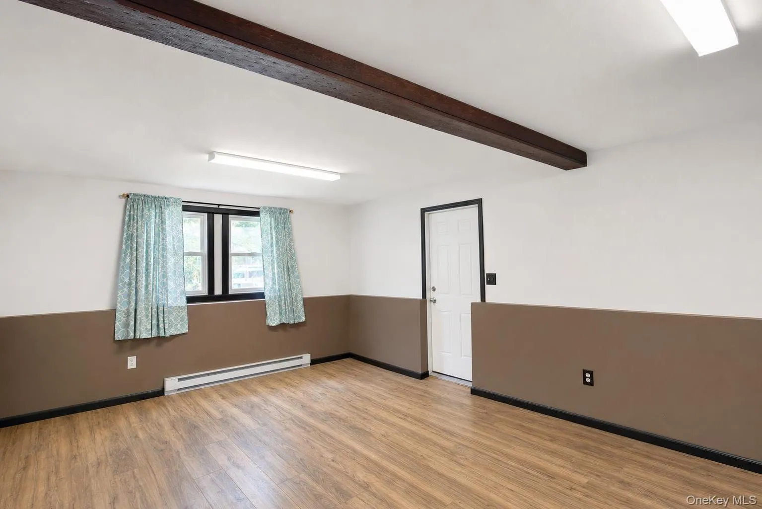 Wood-finish flooring, exposed ceiling beam and garage access Wood-finish flooring, exposed ceiling beam and garage access