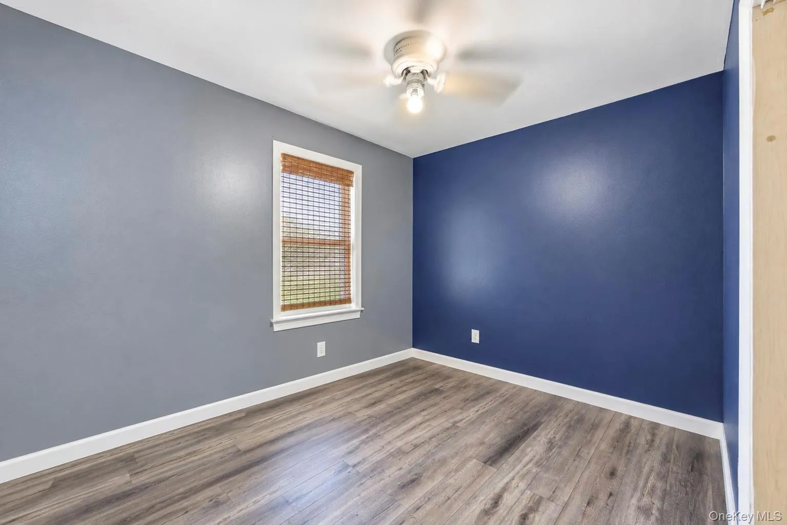 Wood-finish flooring with crisp white baseboards Wood-finish flooring with crisp white baseboards