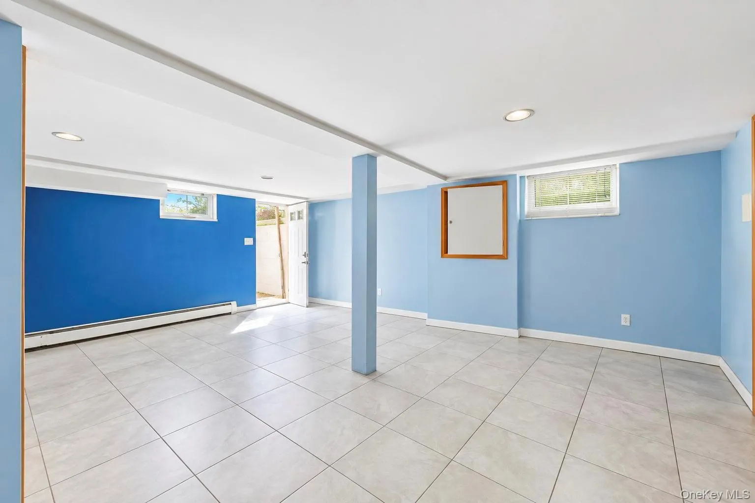 Recessed ceiling lighting, tiled flooring, wood-framed window, and a wood-framed wall panel Recessed ceiling lighting, tiled flooring, wood-framed window, and a wood-framed wall panel