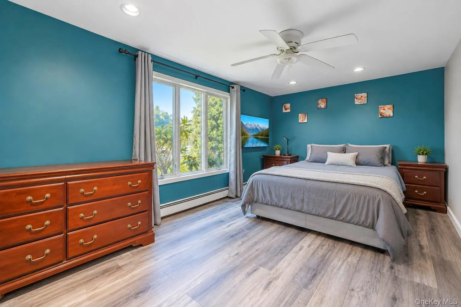 Recessed lighting, wood-finish flooring, ceiling fan, and large window Recessed lighting, wood-finish flooring, ceiling fan, and large window