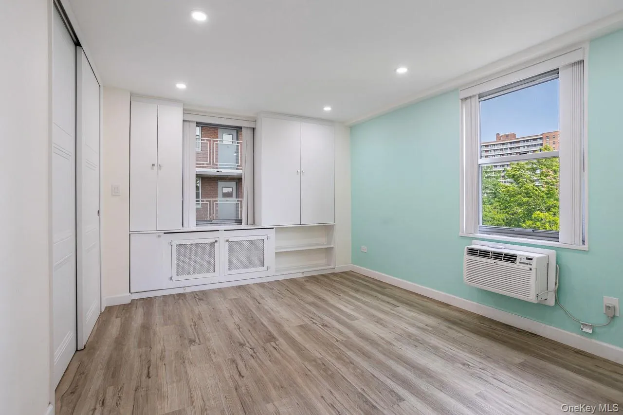 Wood-finish flooring, recessed lighting, built-in cabinetry, sliding closet doors, and an operable window Wood-finish flooring, recessed lighting, built-in cabinetry, sliding closet doors, and an operable window