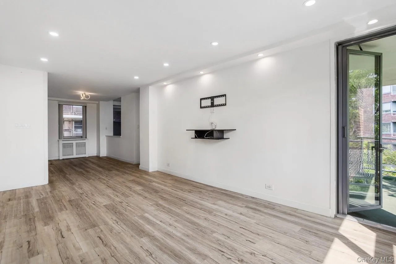 Recessed lighting, wood-finish flooring, sliding glass door, built-in shelving, window with radiator enclosure Recessed lighting, wood-finish flooring, sliding glass door, built-in shelving, window with radiator enclosure