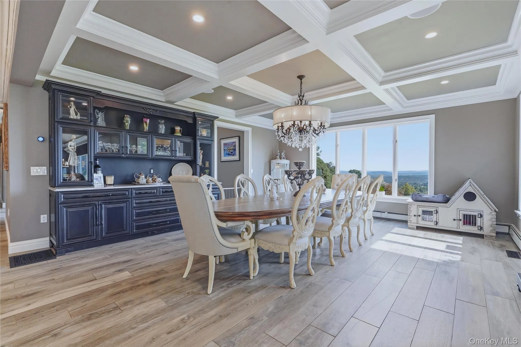 Coffer ceiling with recessed lighting, dark built-in display cabinetry with quartzite counter tops, and large picture windows Coffer ceiling with recessed lighting, dark built-in display cabinetry with quartzite counter tops, and large picture windows
