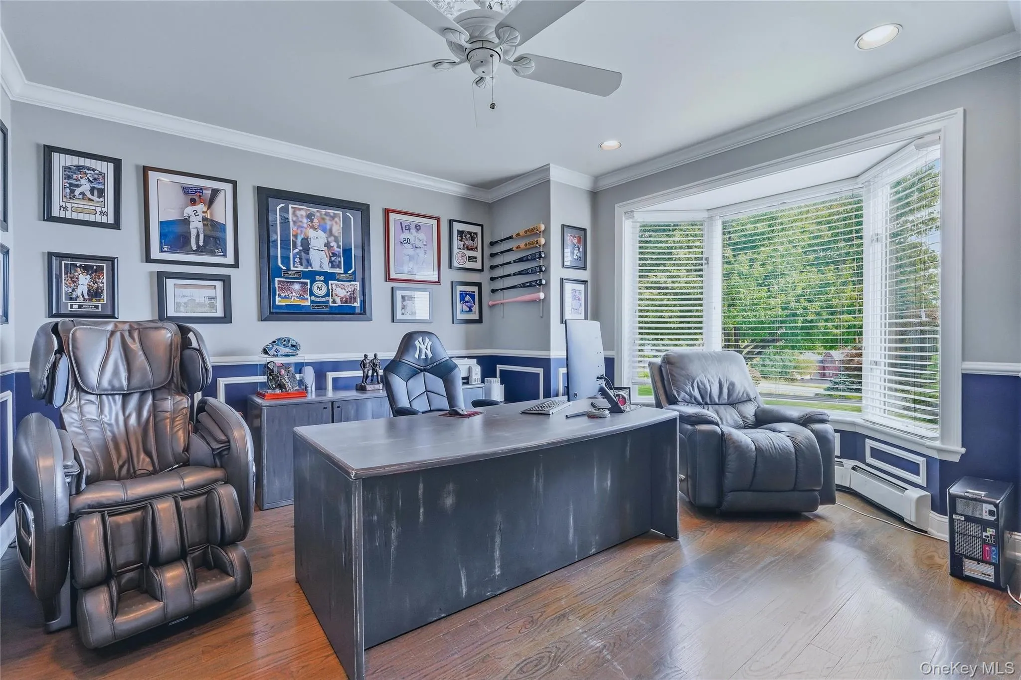 Oak hardwood flooring, recessed lighting, ceiling fan, crown molding, and a bay window Oak hardwood flooring, recessed lighting, ceiling fan, crown molding, and a bay window