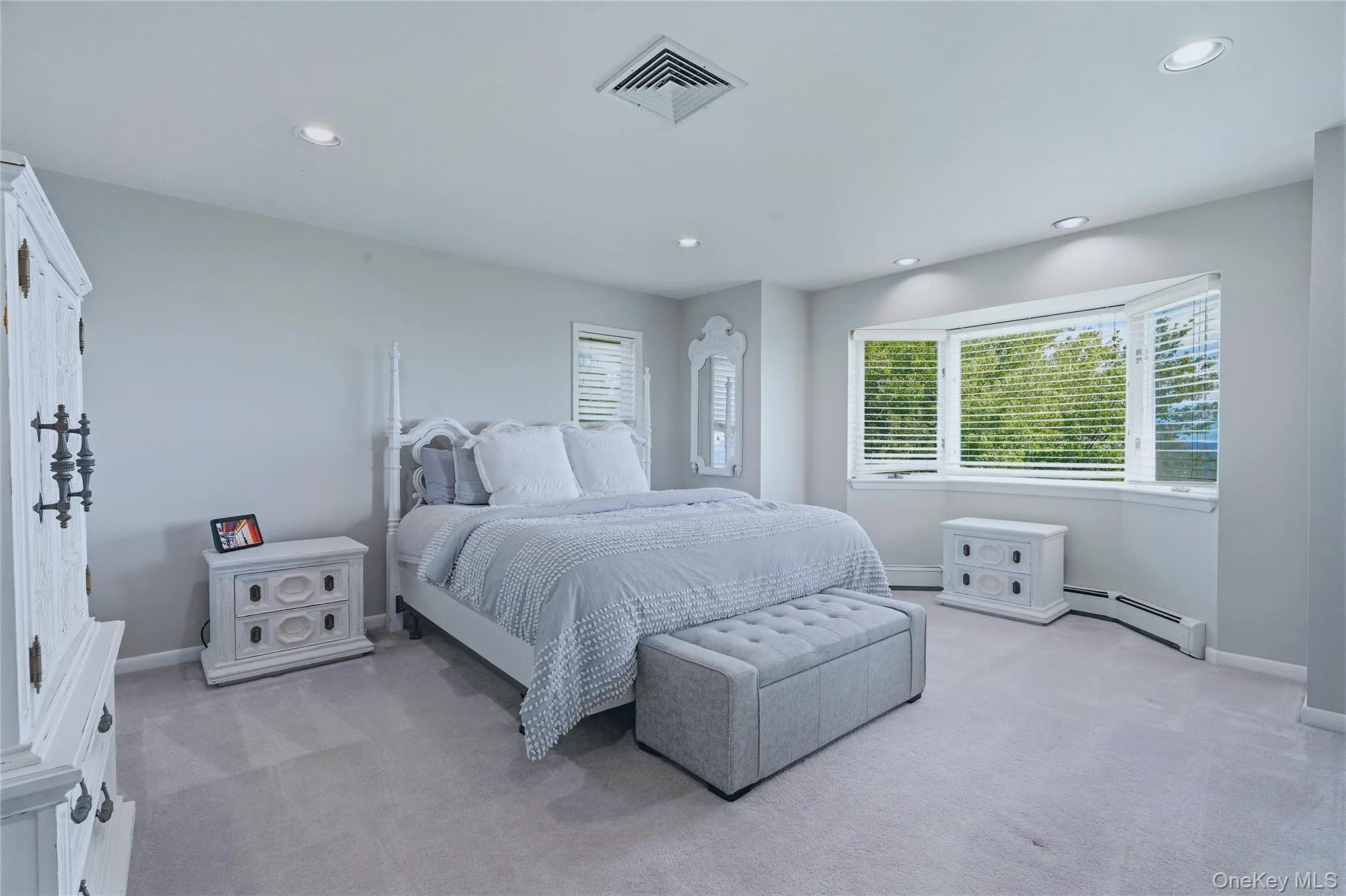 Bedroom 2, recessed lighting, large bay window, light grey wall paint, grey carpet, and window blinds and views Bedroom 2, recessed lighting, large bay window, light grey wall paint, grey carpet, and window blinds and views