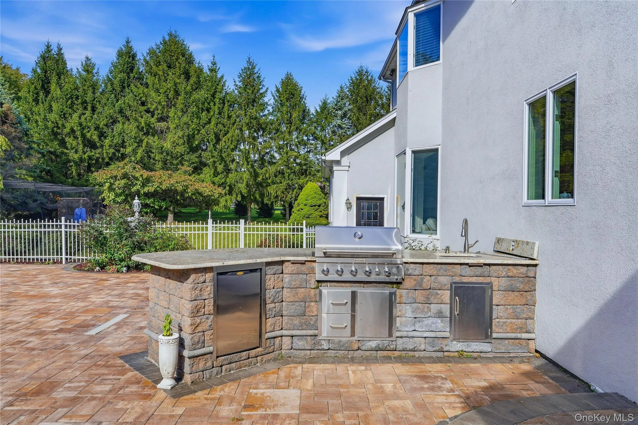 Outdoor kitchen featuring a built-in grill, sink Outdoor kitchen featuring a built-in grill, sink
