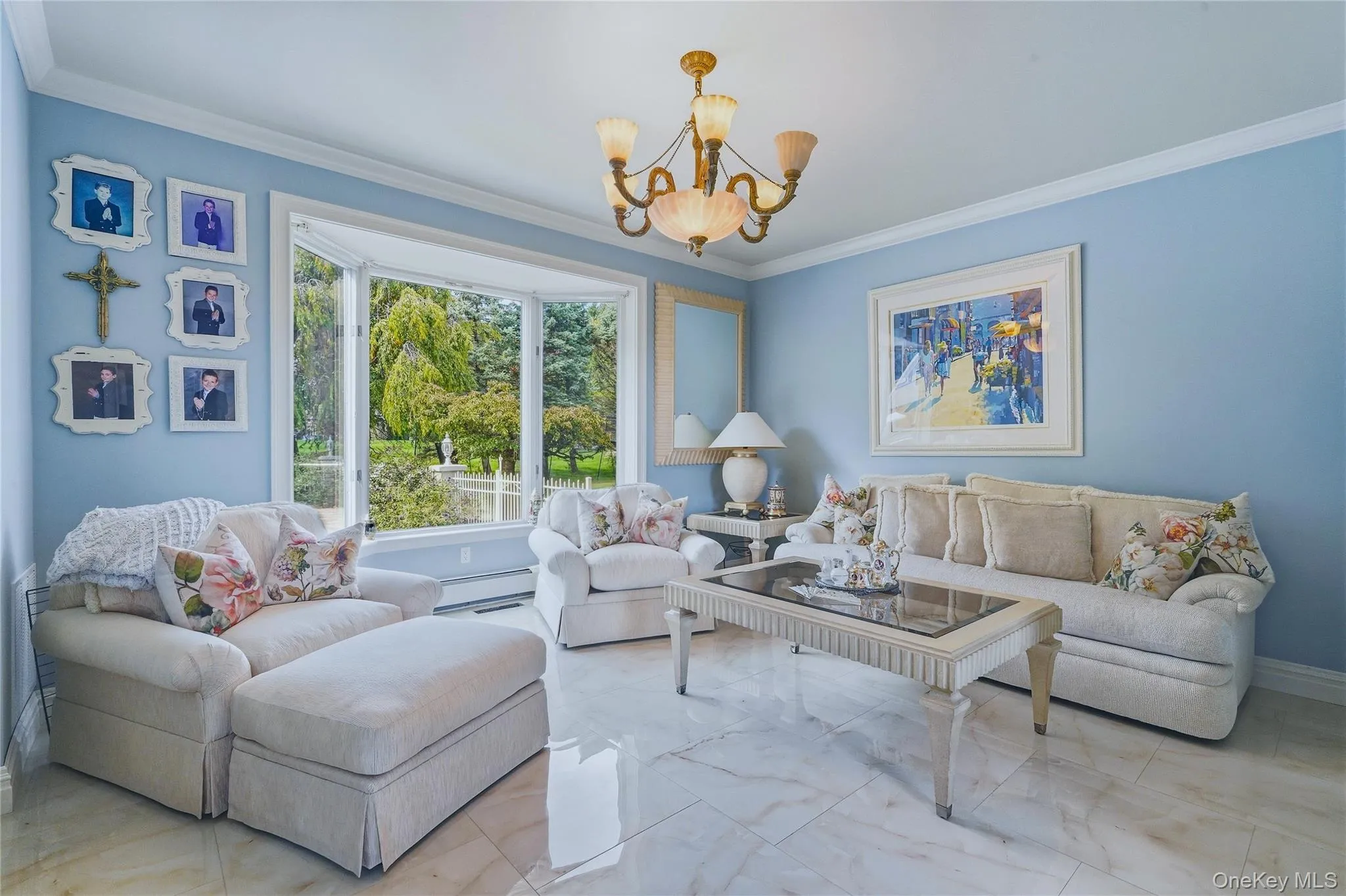 Formal living room, bay window offering natural light, polished tile flooring, and crown molding Formal living room, bay window offering natural light, polished tile flooring, and crown molding