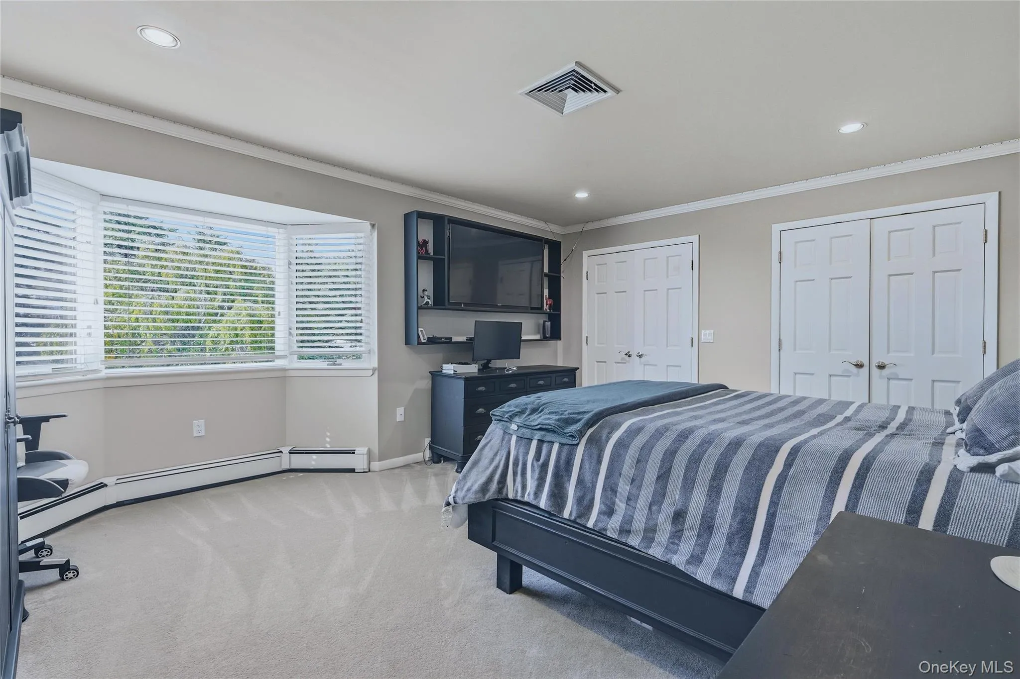 Bedroom 3, bay window with blinds, recessed lighting, crown molding, and two panel doors Bedroom 3, bay window with blinds, recessed lighting, crown molding, and two panel doors