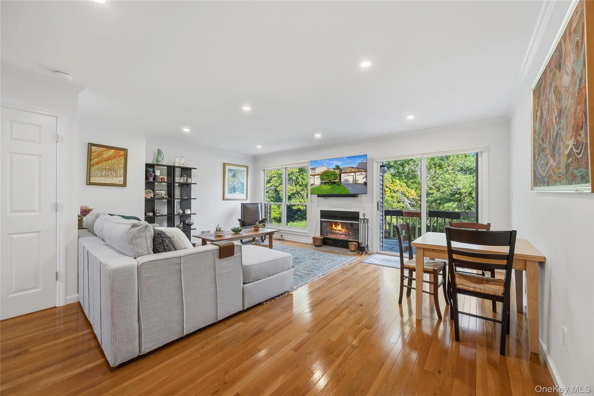 Living Room with wood burning Fireplace and sliding glass door to wood deck Living Room with wood burning Fireplace and sliding glass door to wood deck