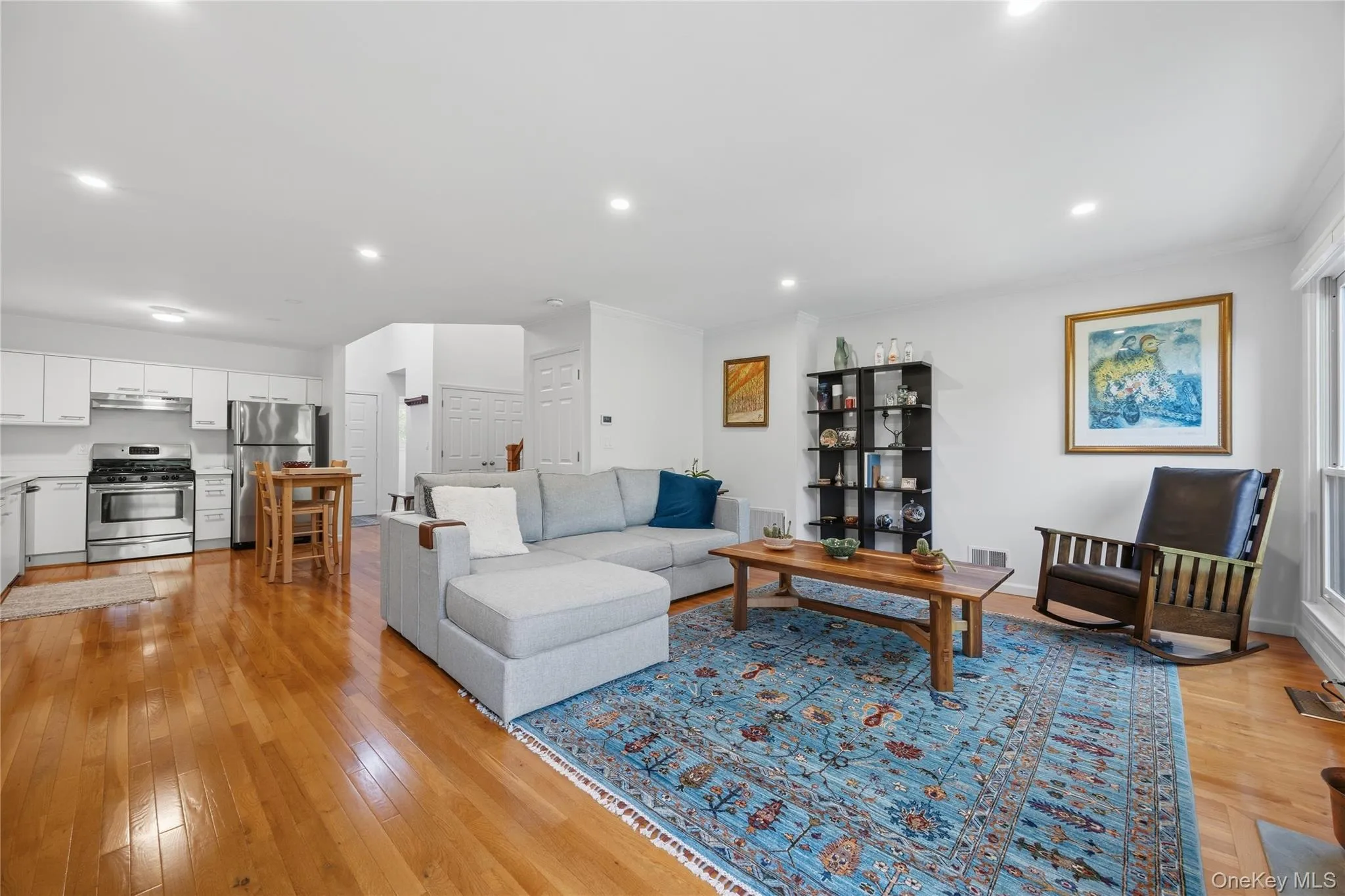 View of Living Room with Kitchen beyond; recessed lights & hardwood floors View of Living Room with Kitchen beyond; recessed lights & hardwood floors
