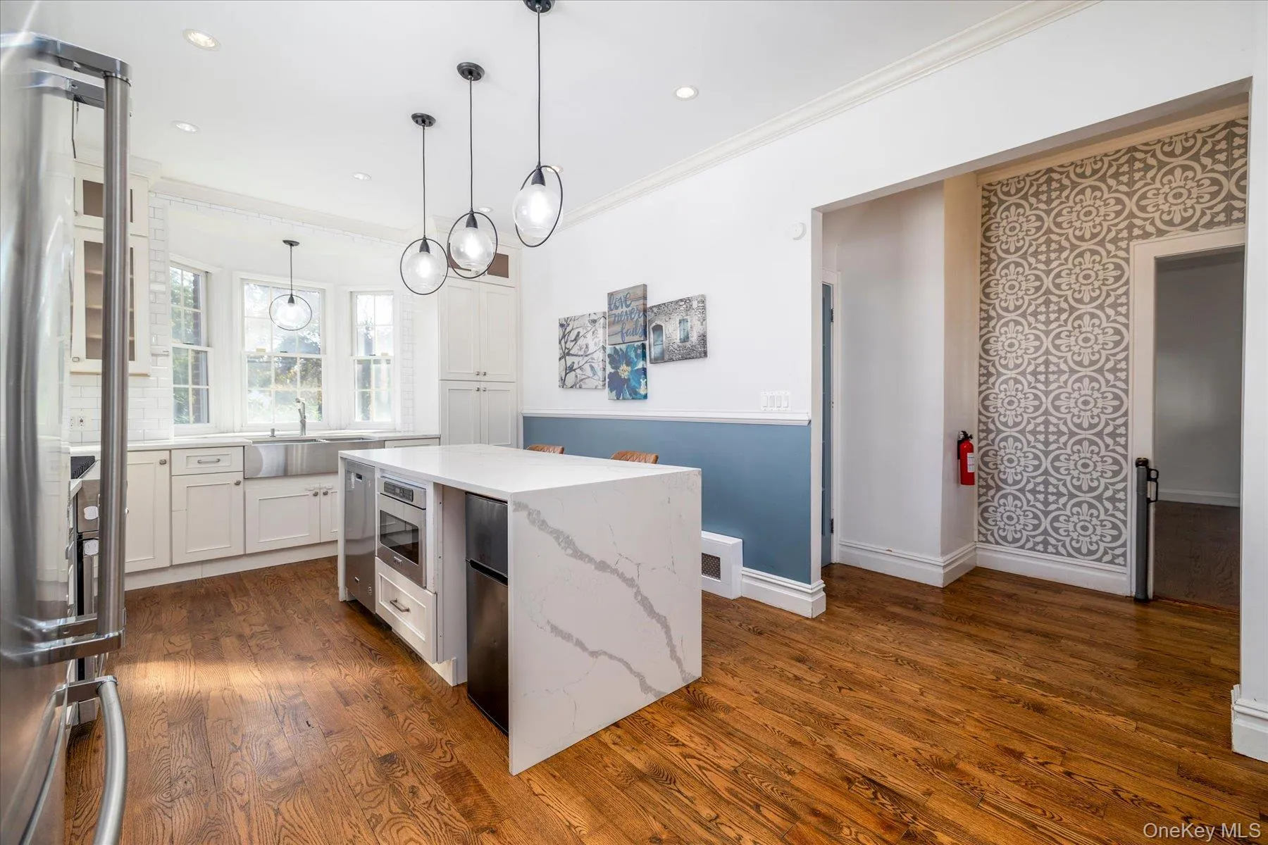 updated kitchen, center island with waterfall countertops and stainless steel appliances. updated kitchen, center island with waterfall countertops and stainless steel appliances.